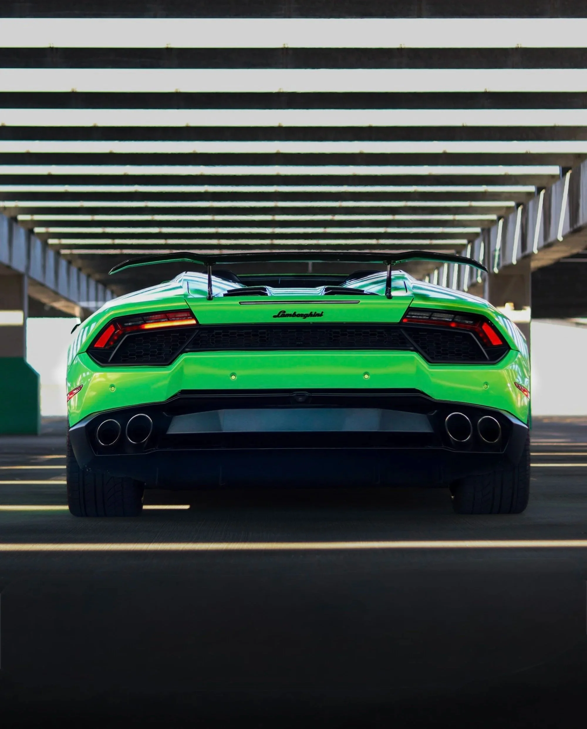 Rear view of green 2019 Lamborghini Huracan Spyder with LED taillights, available for rental in Tampa, Florida.