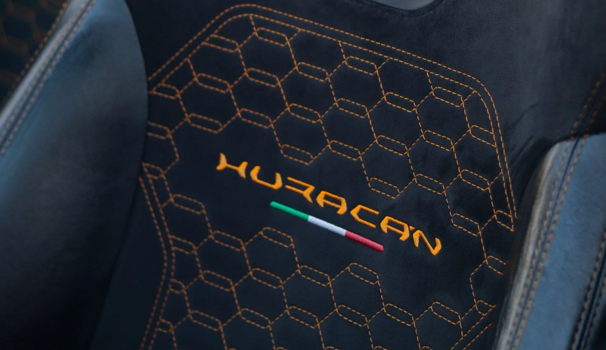 Huracan embroidered sport seat inside 2019 Lamborghini Huracan Spyder rental in Tampa, Florida.