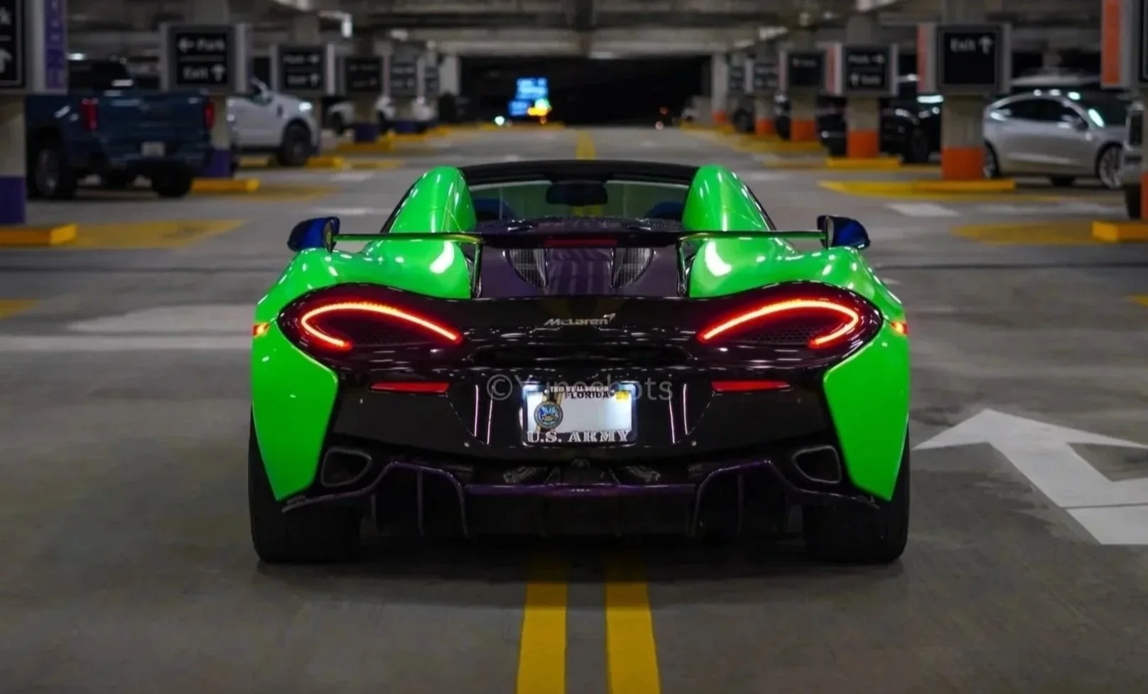 Rear view of the custom green 2020 McLaren 570S Spyder with purple forged carbon fiber accents and LED taillights.