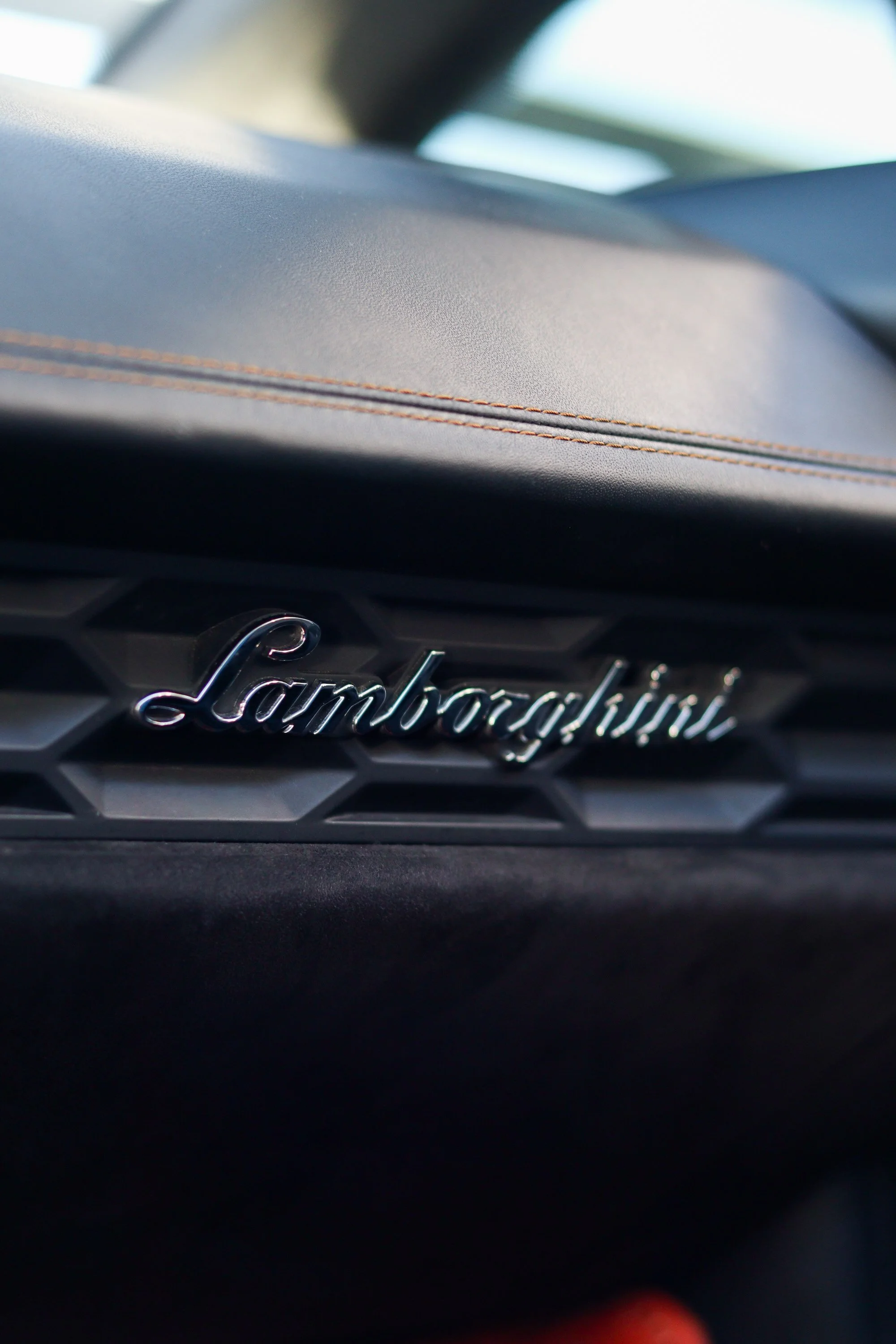 Lamborghini interior badge detail inside 2019 Huracan Spyder exotic rental in Tampa, Florida.