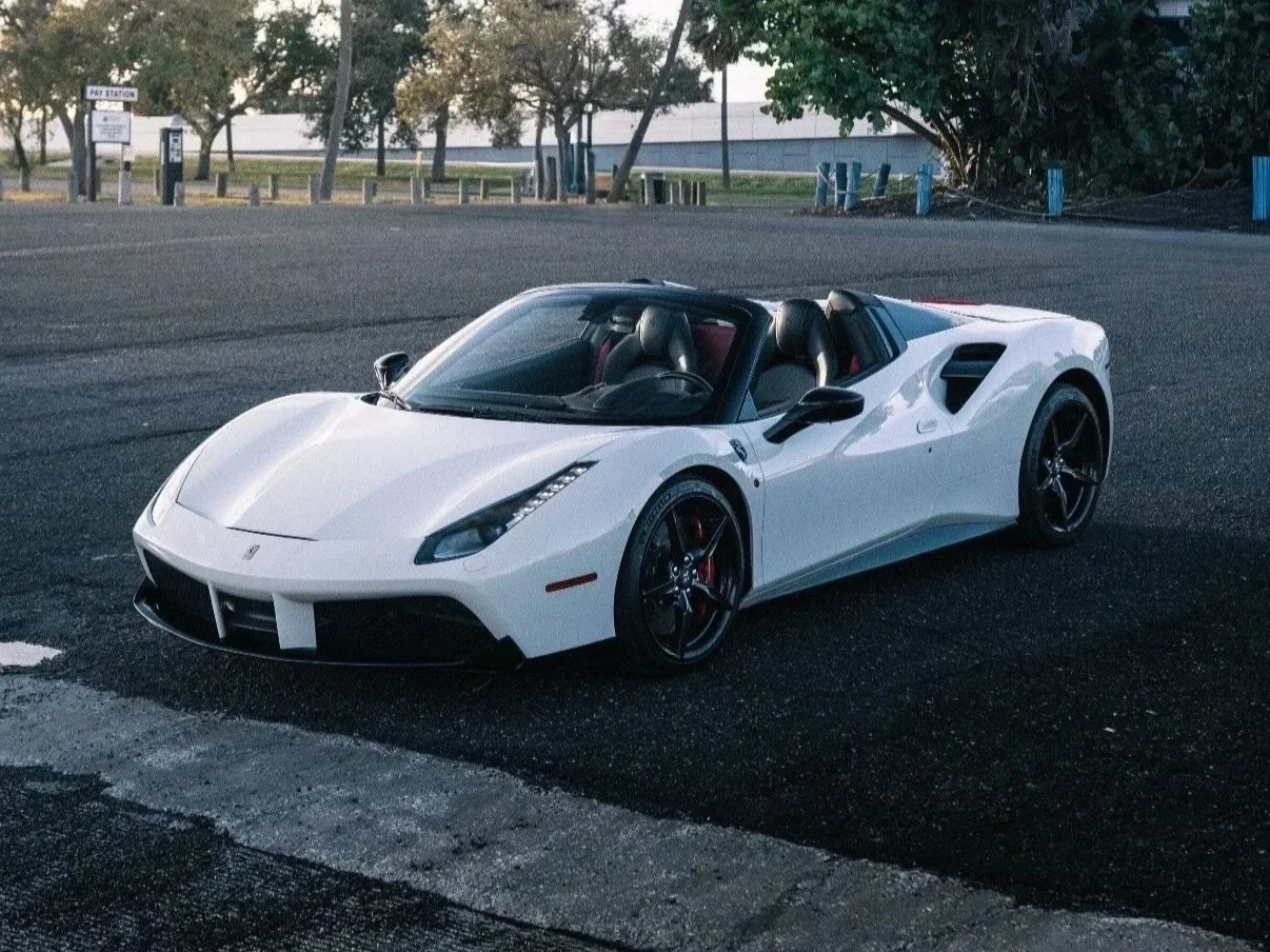 White Ferrari 488 Spyder convertible driving exotic rental Tampa