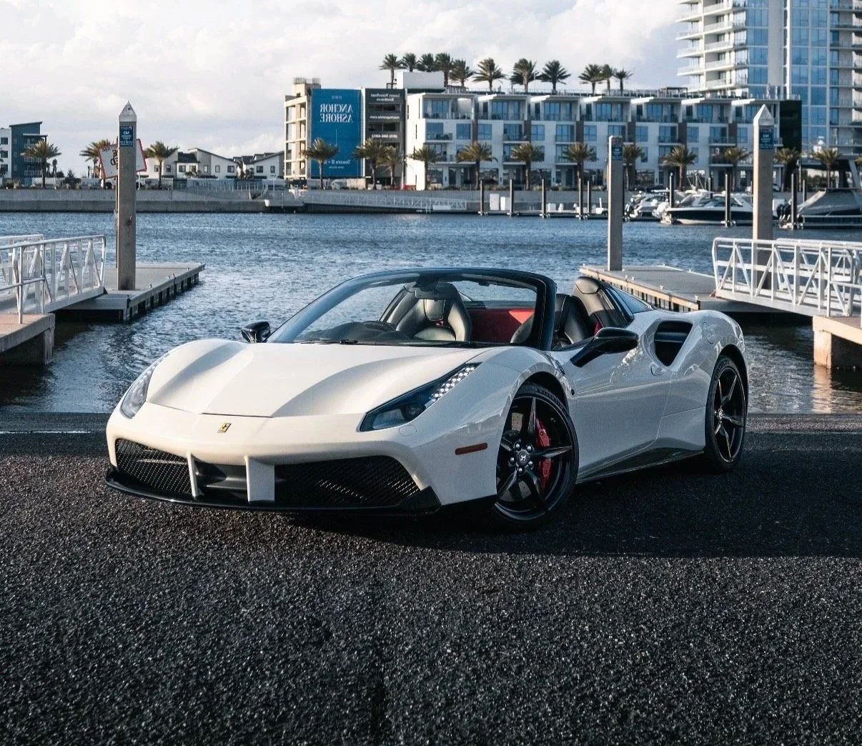 White Ferrari 488 Spyder rental parked at Tampa marina waterfront