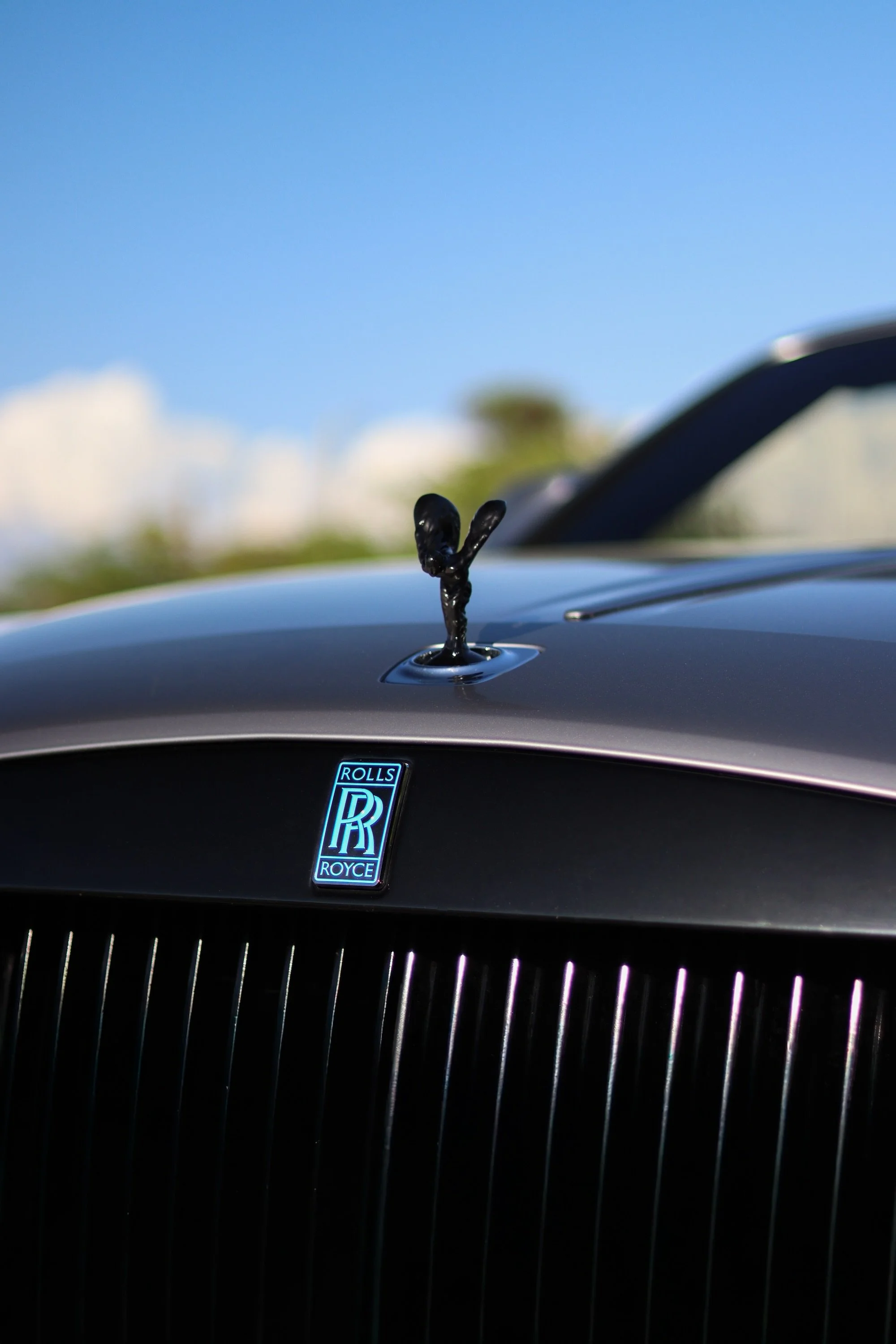 Spirit of Ecstasy hood ornament on Rolls-Royce Dawn luxury convertible