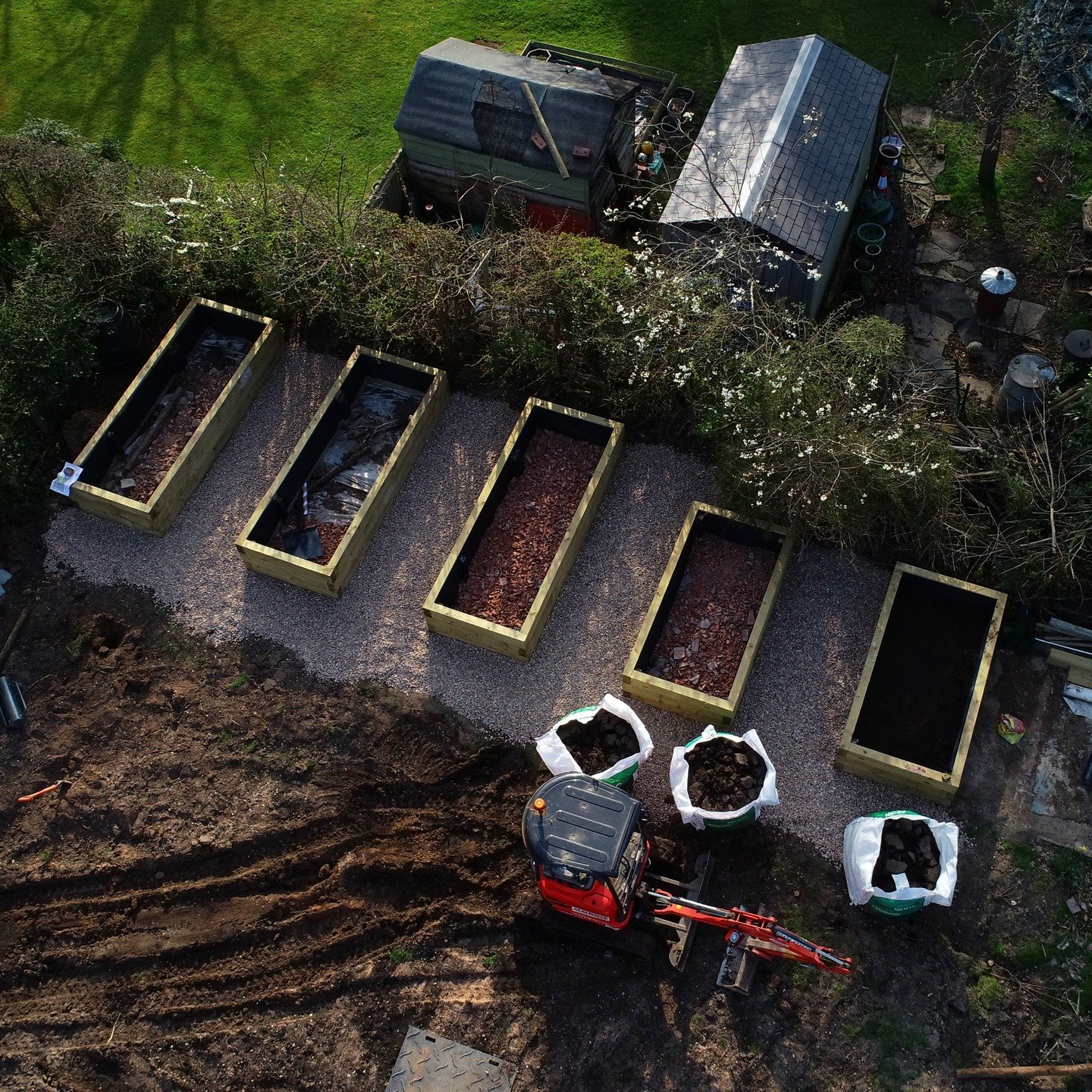 The work never stops! Today, we&rsquo;re lining the planters, adding a hardcore base for drainage, and topping them off with rich topsoil. Can&rsquo;t wait to see everything come to life! 🌱

#landscaping #planting #springtime