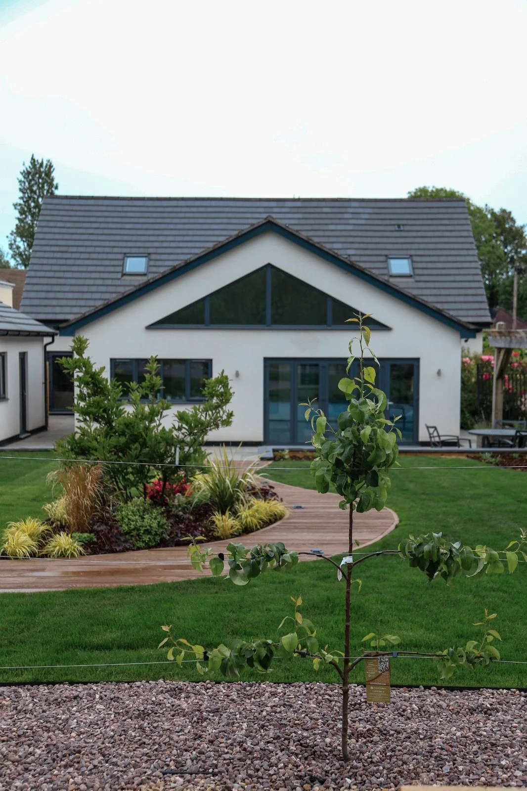 Luxury modern landscaping in Warwickshire, curved composite decking, planting, modern design