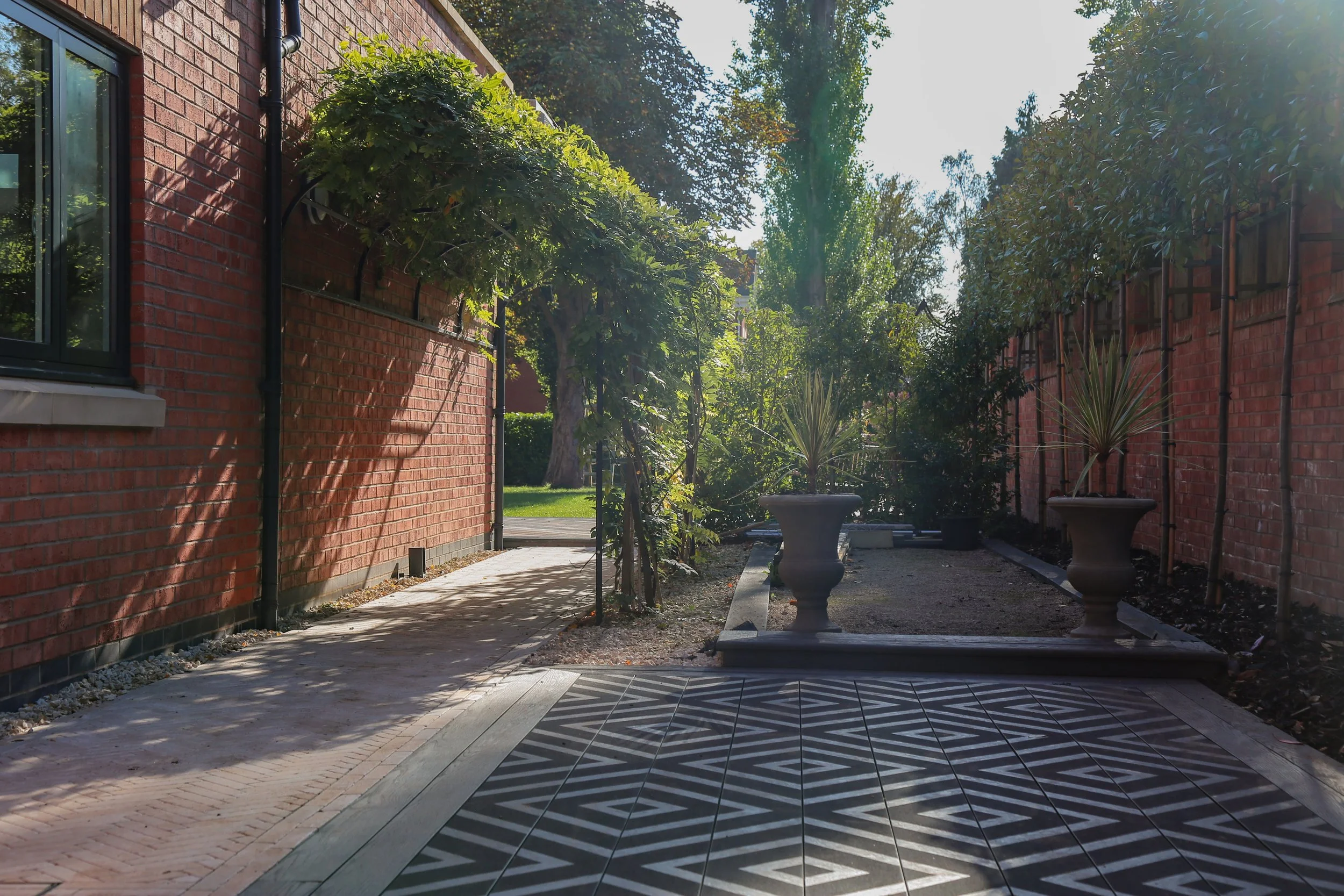 Small outdoor area, with composite decking and natural stone brick pavers