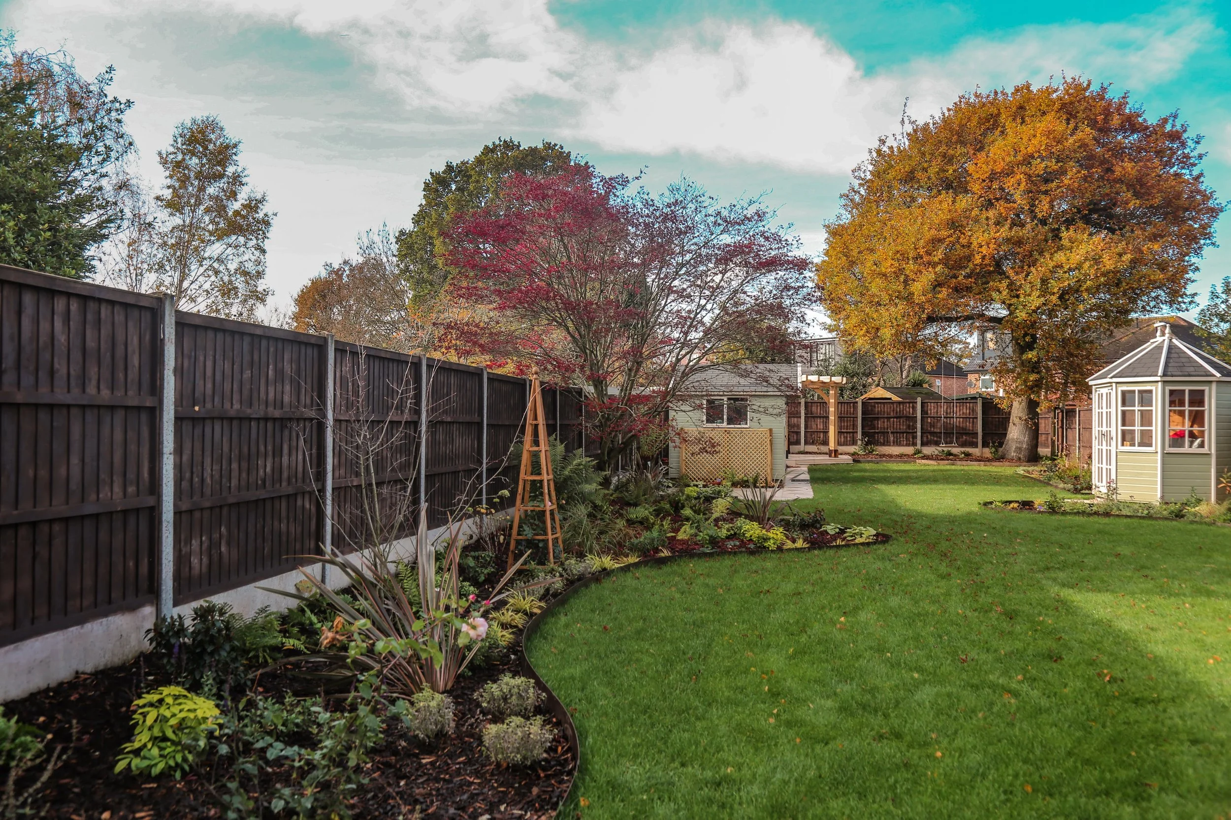 Well designed garden with seasonal planting and turfed lawn