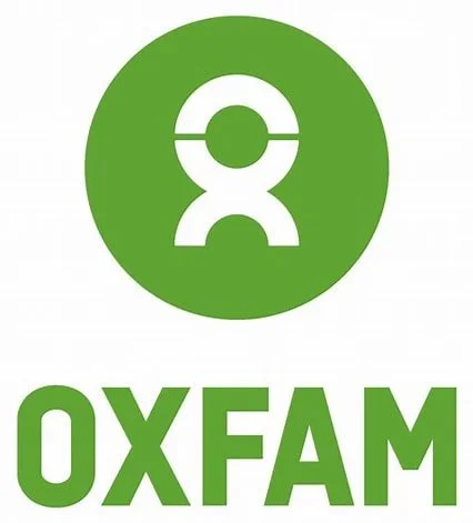 Oxfam logo with a green circle and stylized white emblem above the word 'OXFAM' in green uppercase letters.