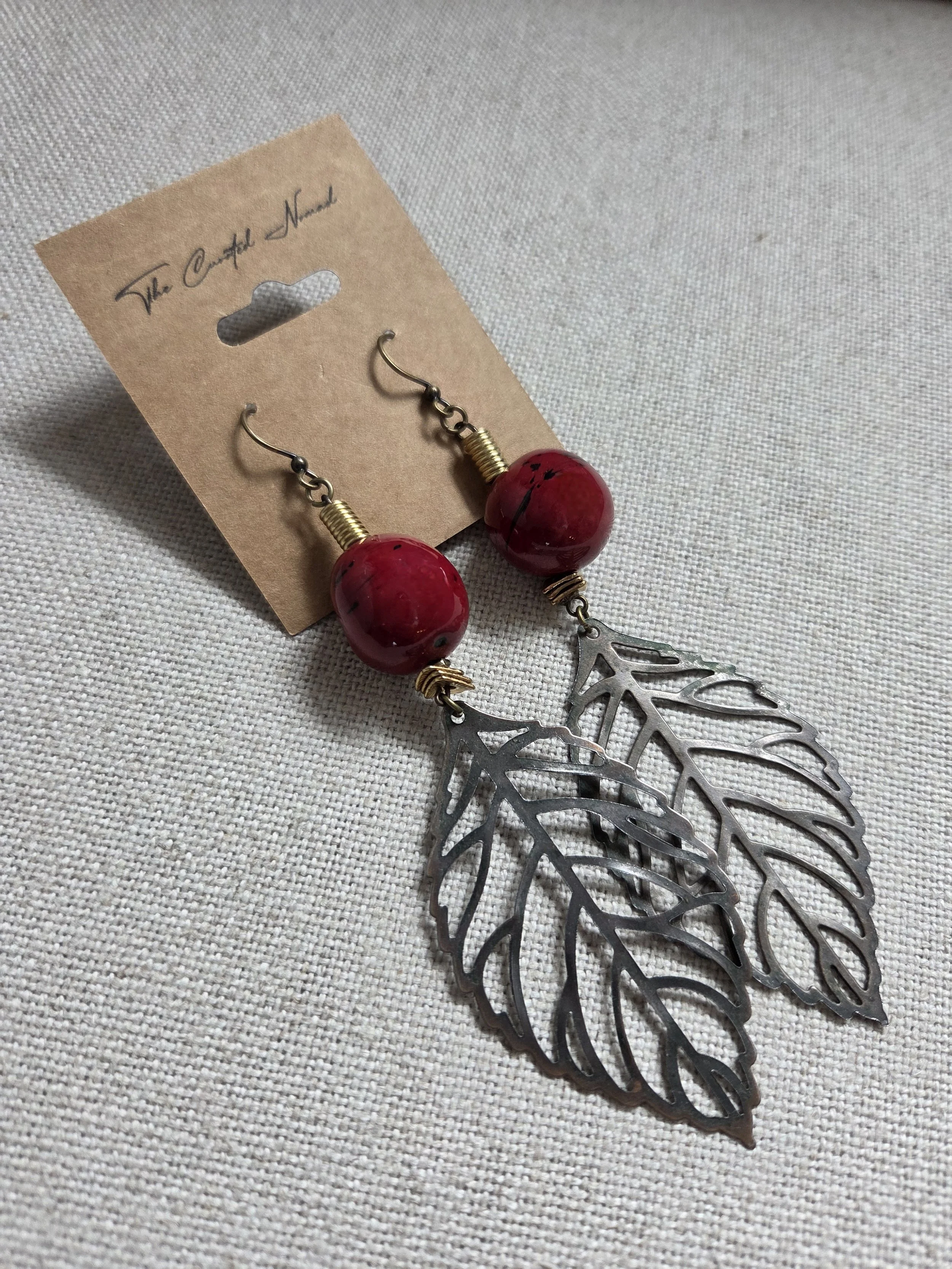 Red marble orb with etched leaves