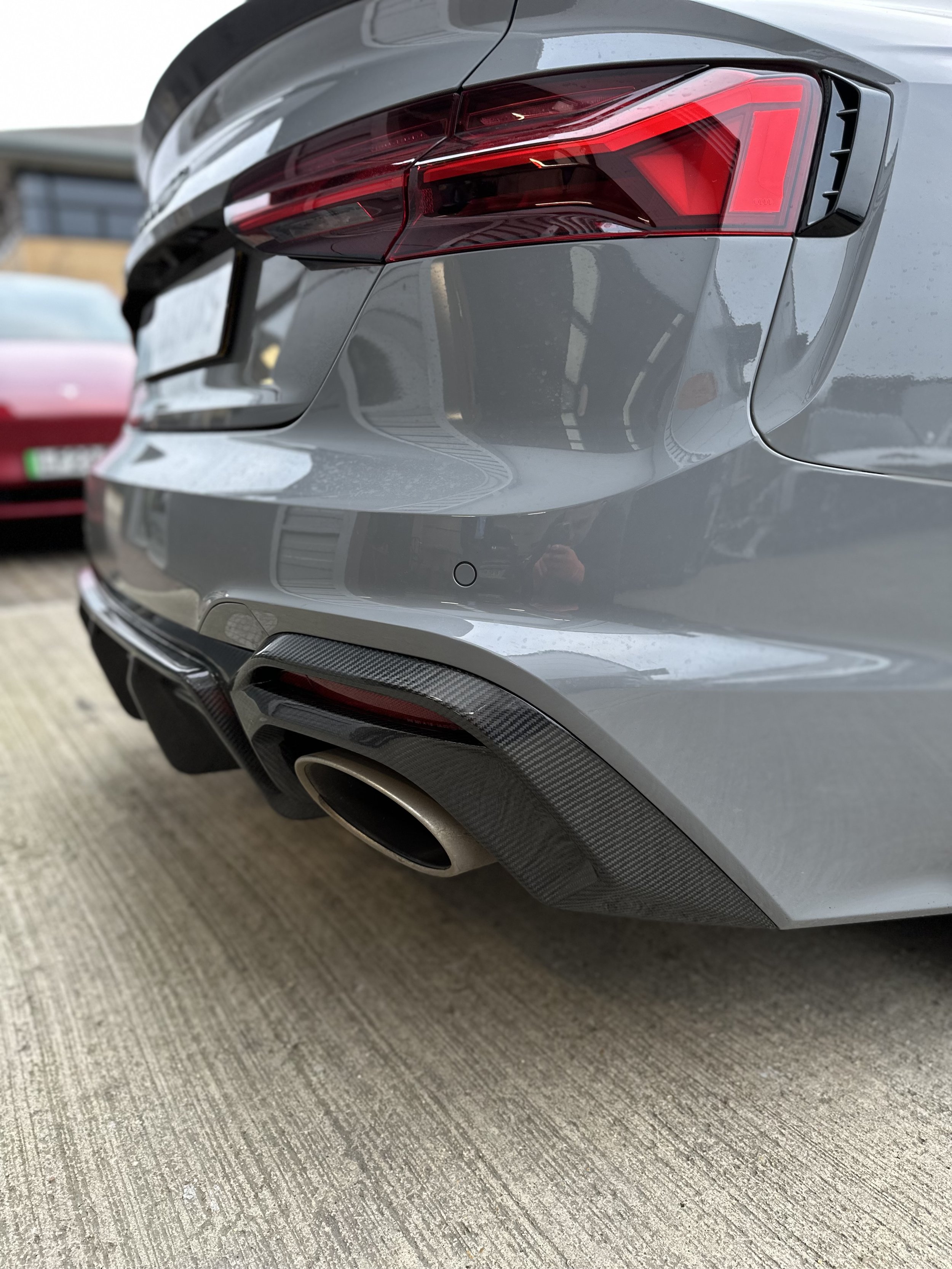 Rear carbon fibre diffuser fitted on a grey Audi.