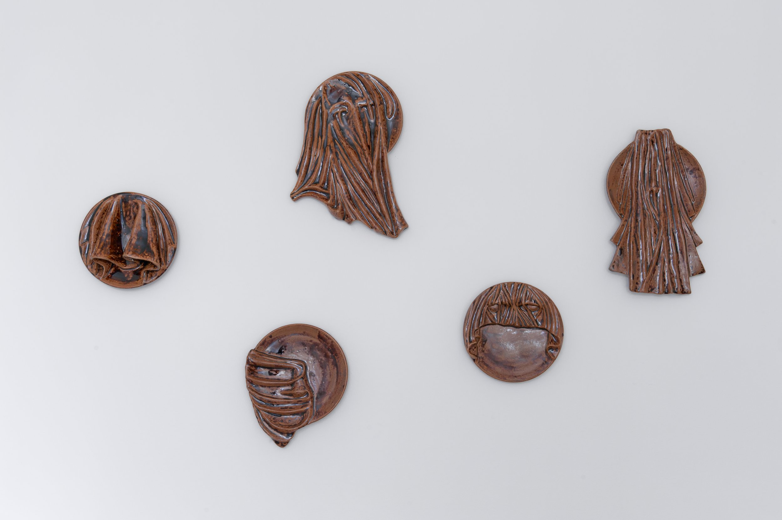 Hooded Plates, 2012. Stoneware. H 20 - 40 cm.