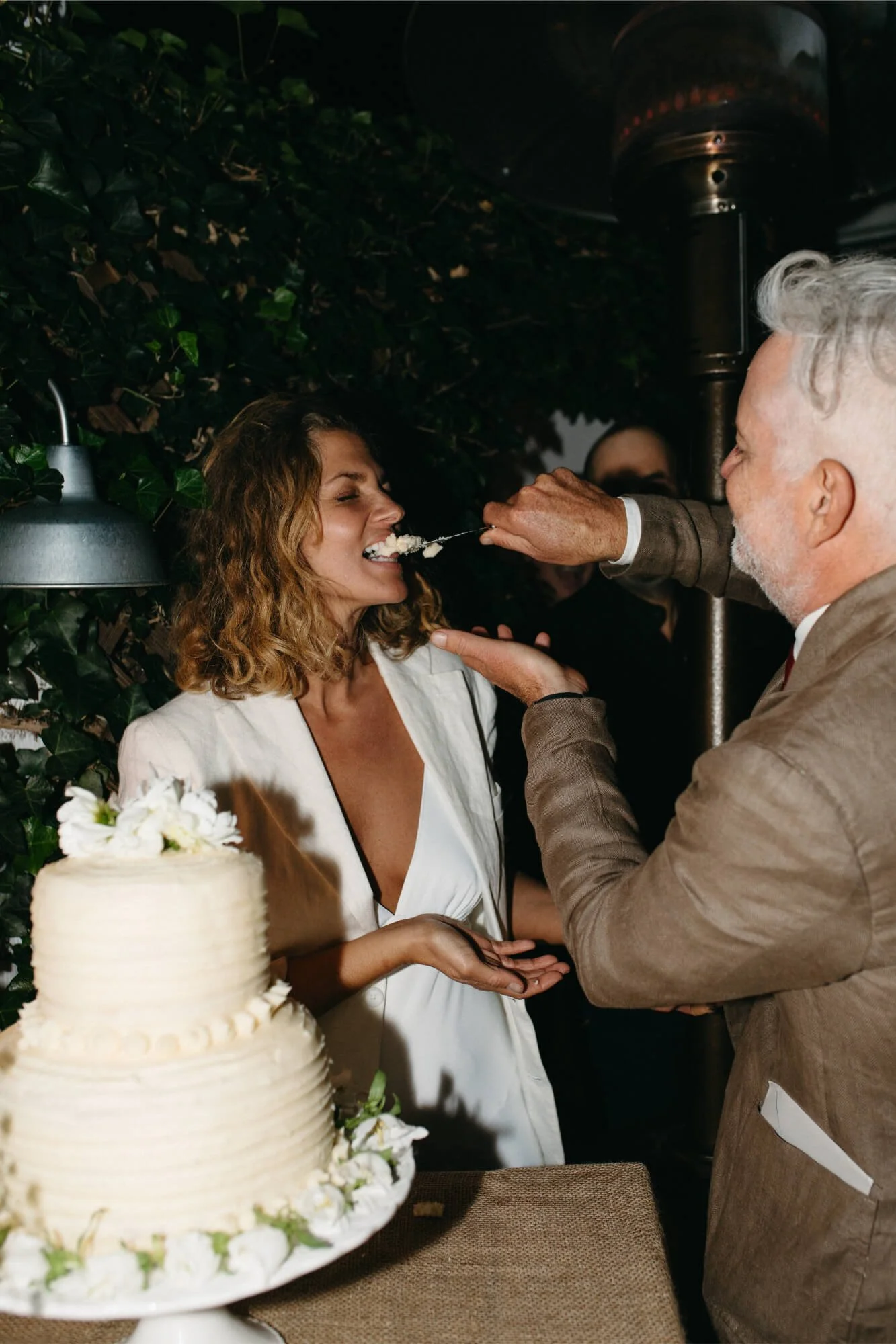 Groom feeding Bride cake at Southampton, NY wedding.