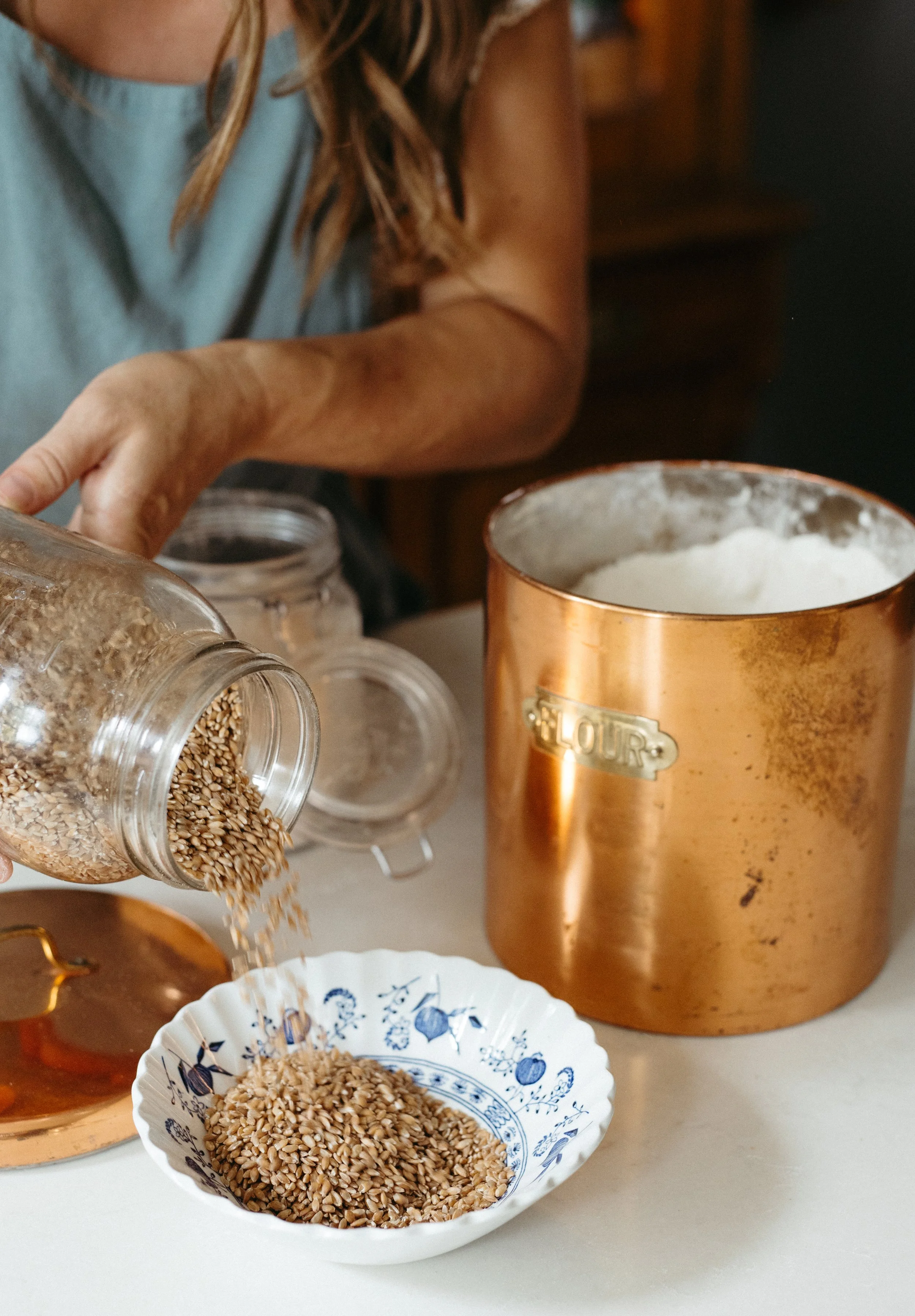 lisa bass pours wheat berries from a jar