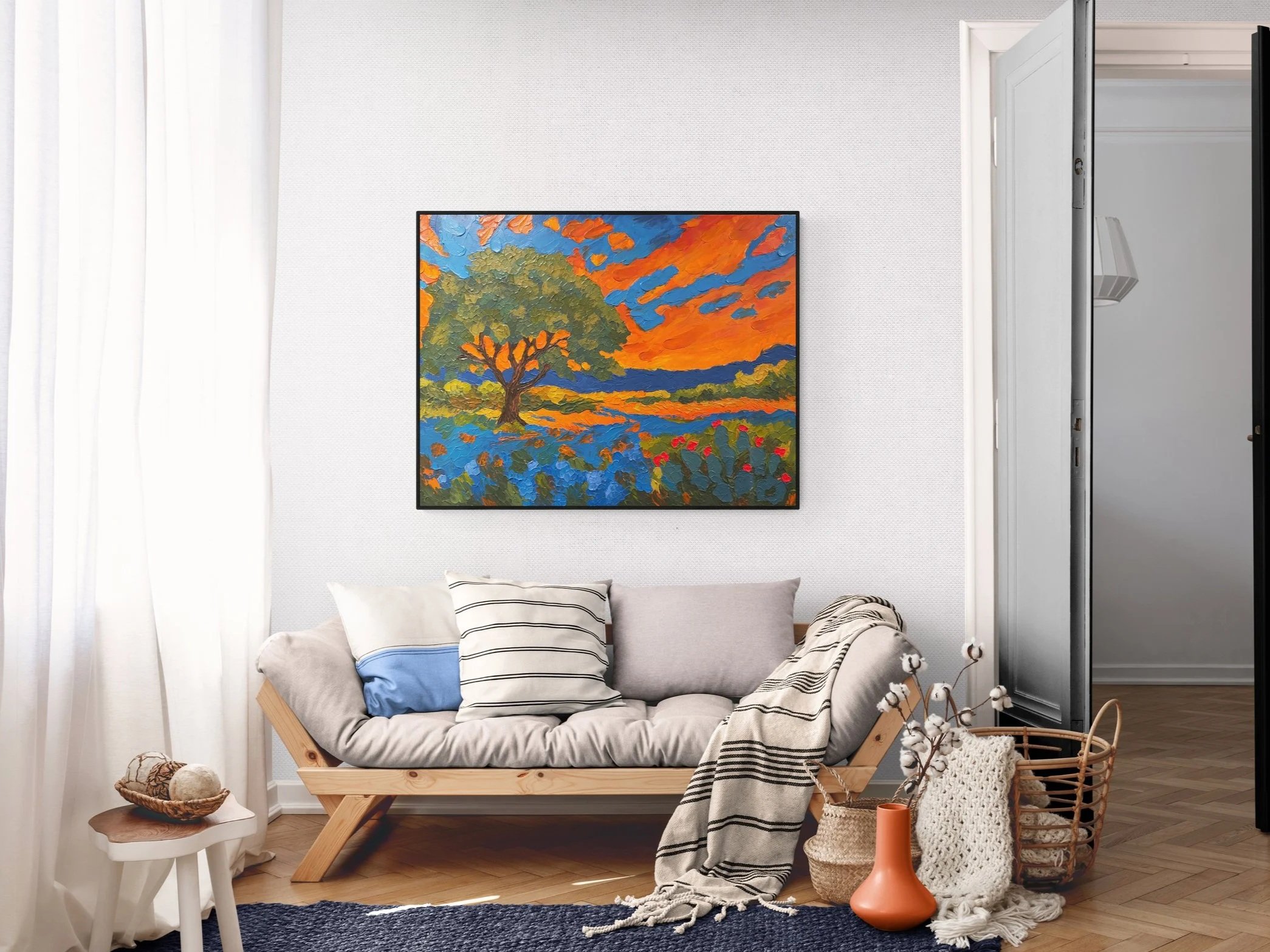 Fiery clouds churn across the horizon, casting their glow over a steadfast live oak, fields of bluebonnets, and blooming cactus. 