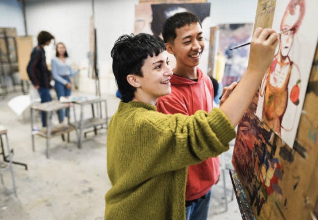 Two teenage students painting