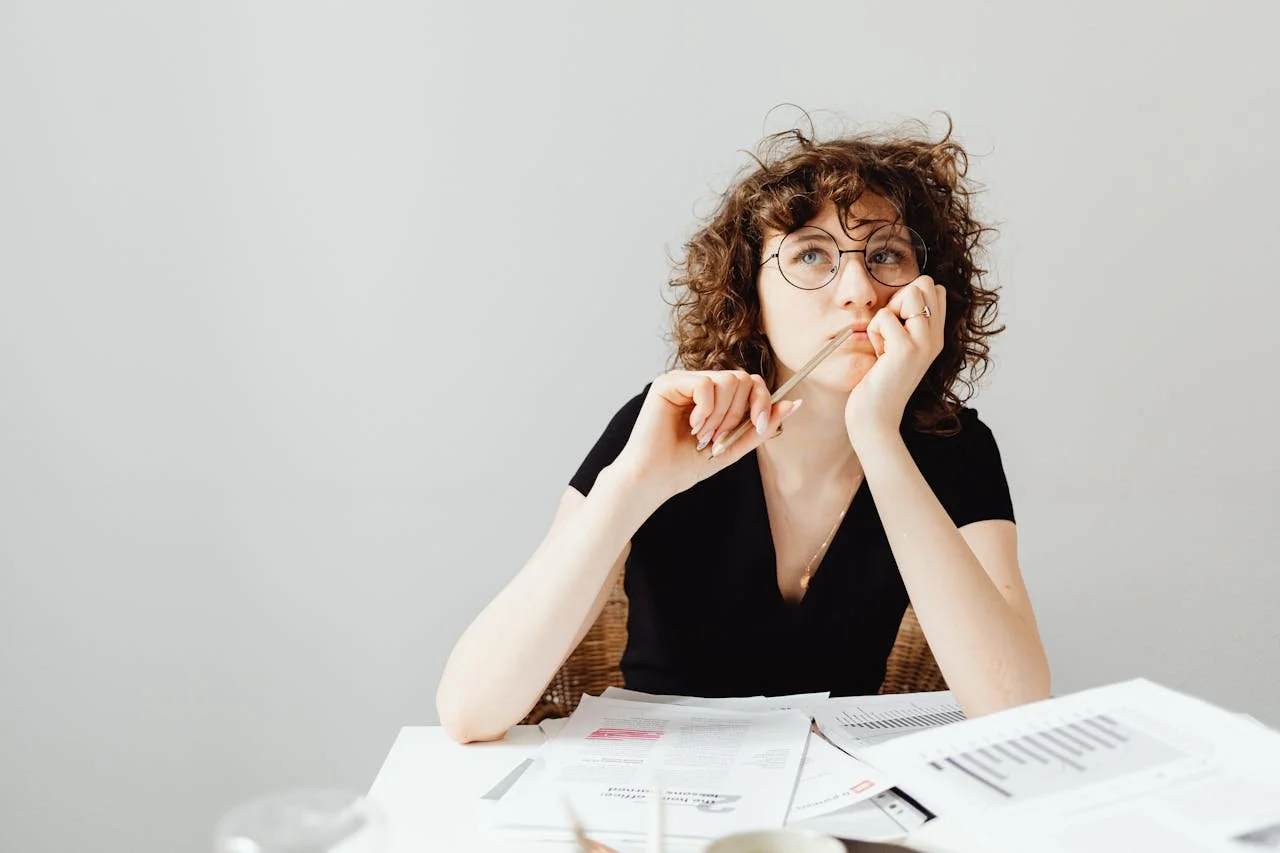 photograph-of-a-woman-with-curly-hair-thinking