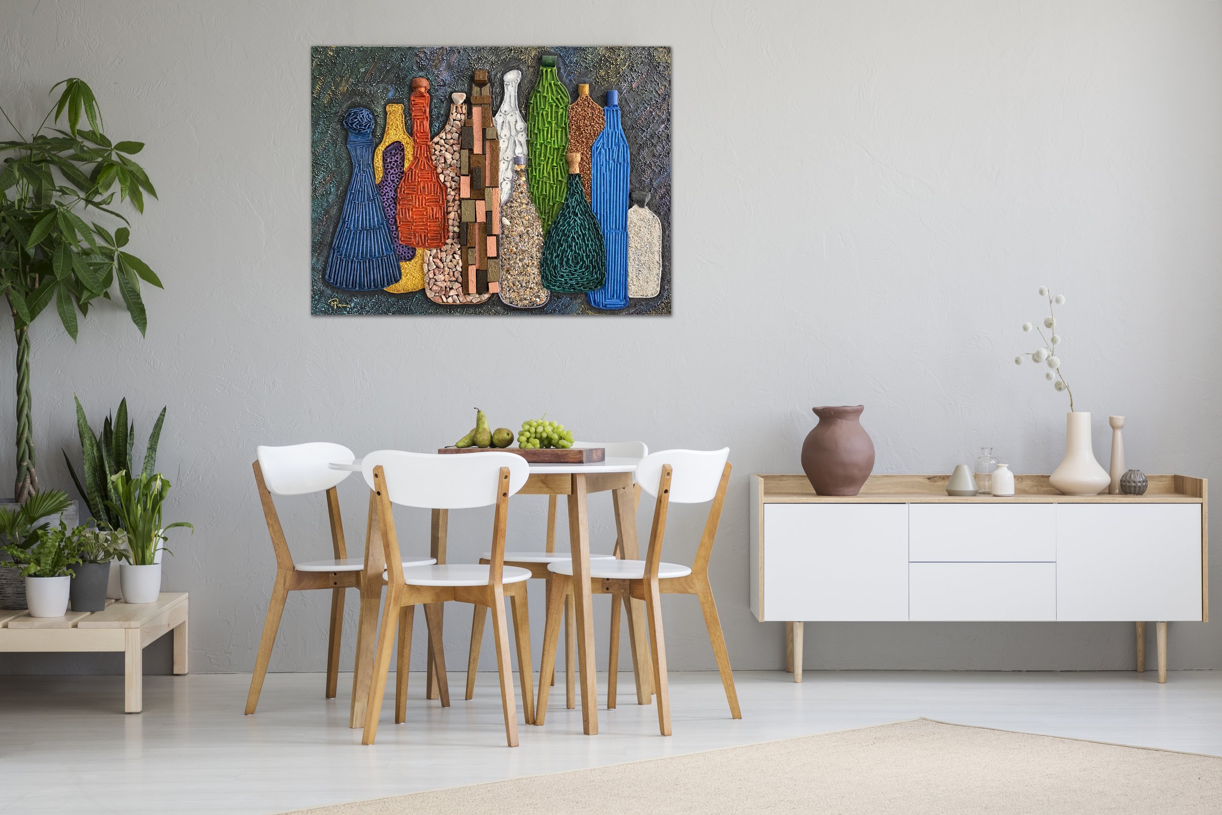 A dining room with a white wall, a wooden dining table with white chairs, a sideboard with decorative vases, and a colorful abstract art piece on the wall.