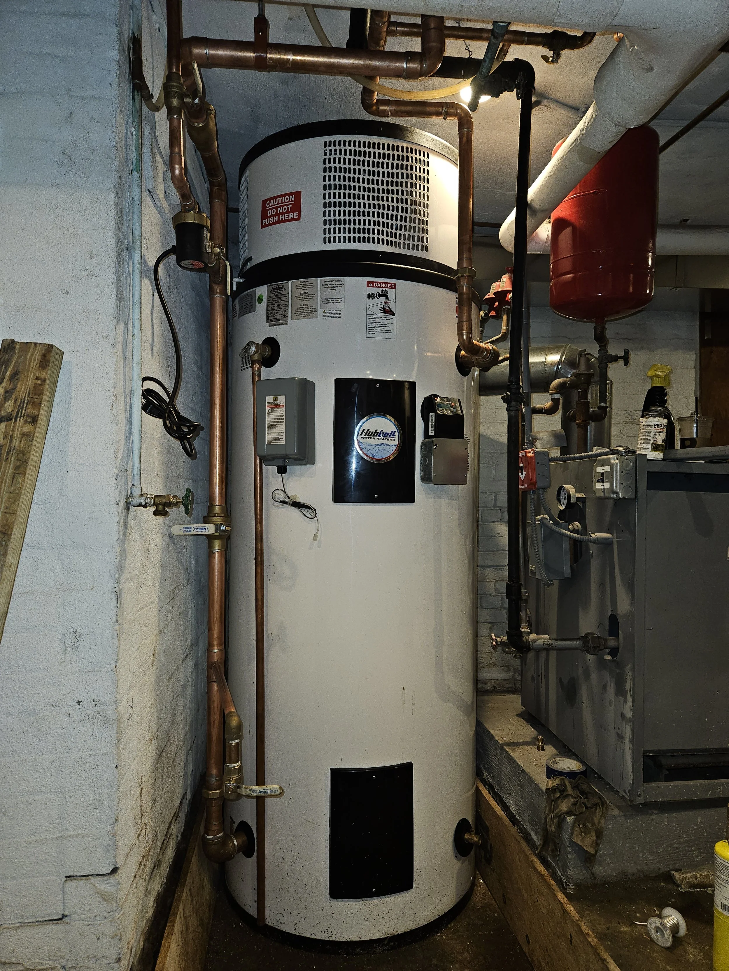 Genesis Plumbing & Heating Installation of a Hybrid Heat Pump Water Heater for Energy Efficiency.