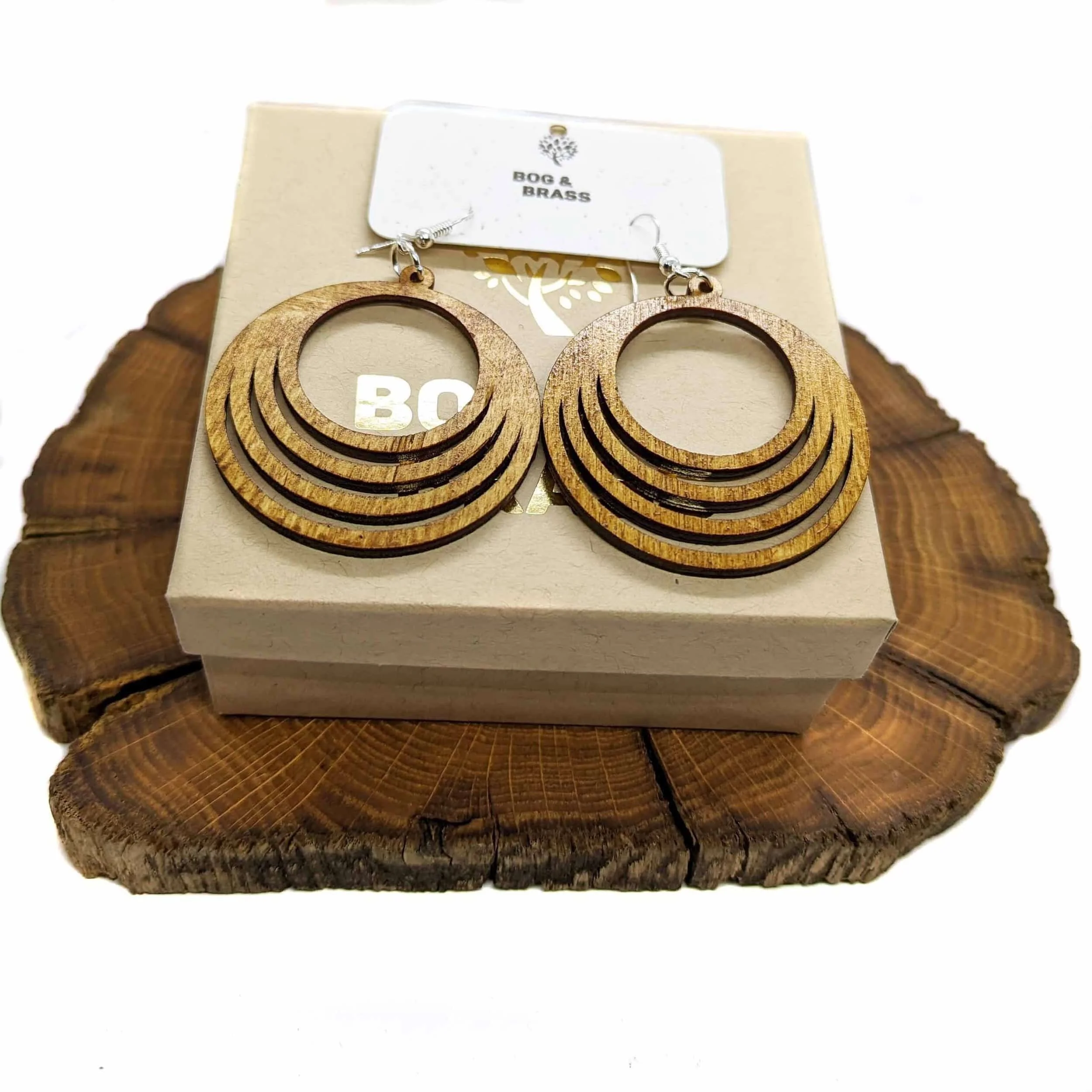 fanned wooden earrings on top of earring box