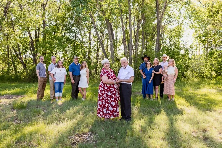 Extended family session in Great Falls, MT  with grandparents holding hands as family looks on