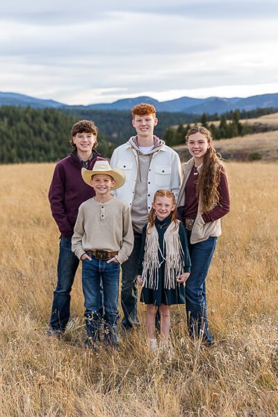 5 smiling kids with mountains in the background at Sluice Boxes state park

