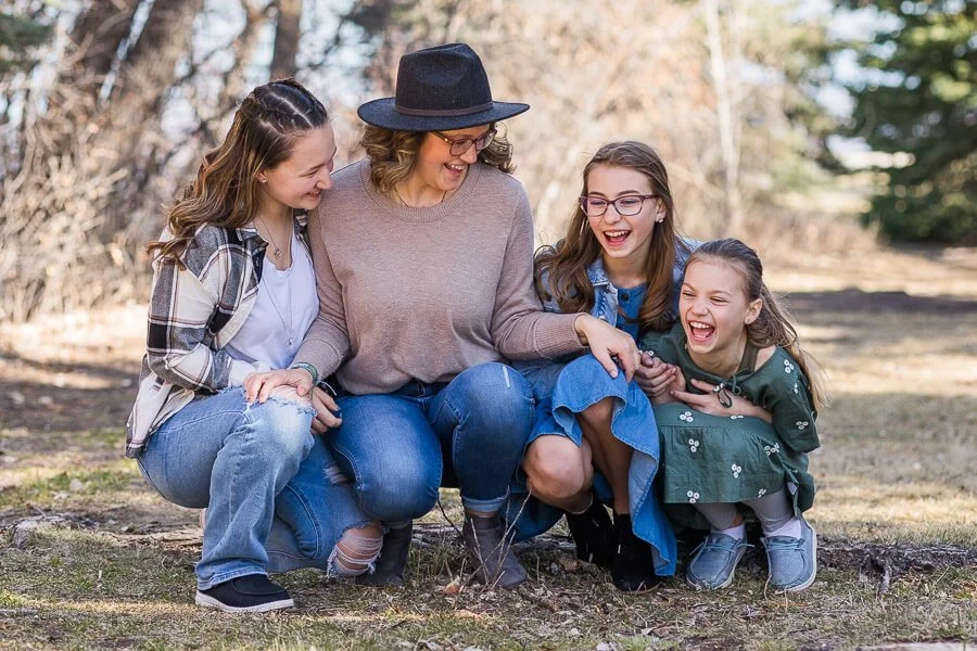 Mom & 3 daughters tickle each other and laugh at Giant Springs State Park in Great Falls, MT