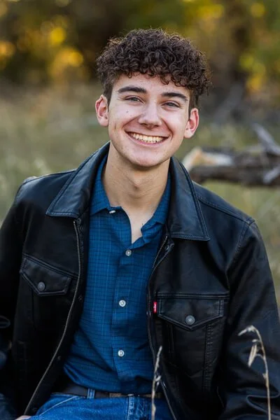 Smiling teen boy wearing black leather jacket