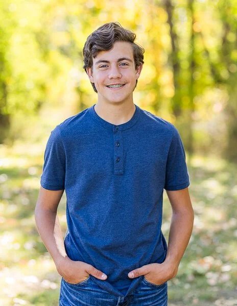 Smiling teen boy in blue henley shirt