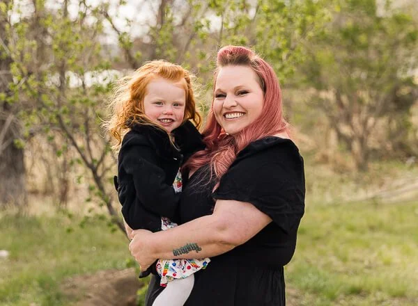 Photo of smiling mom & red-head daughter