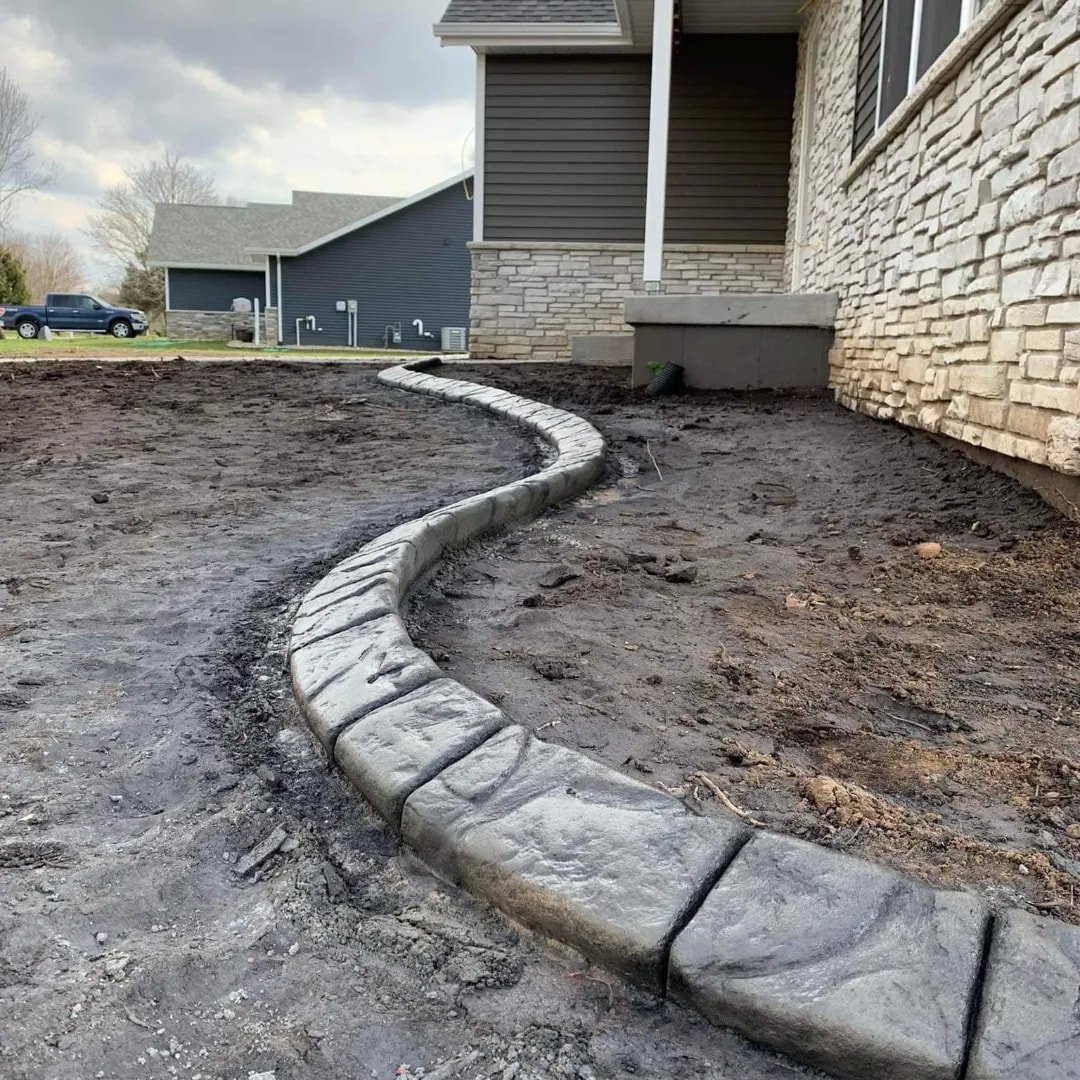 Curved concrete border along a house's garden area