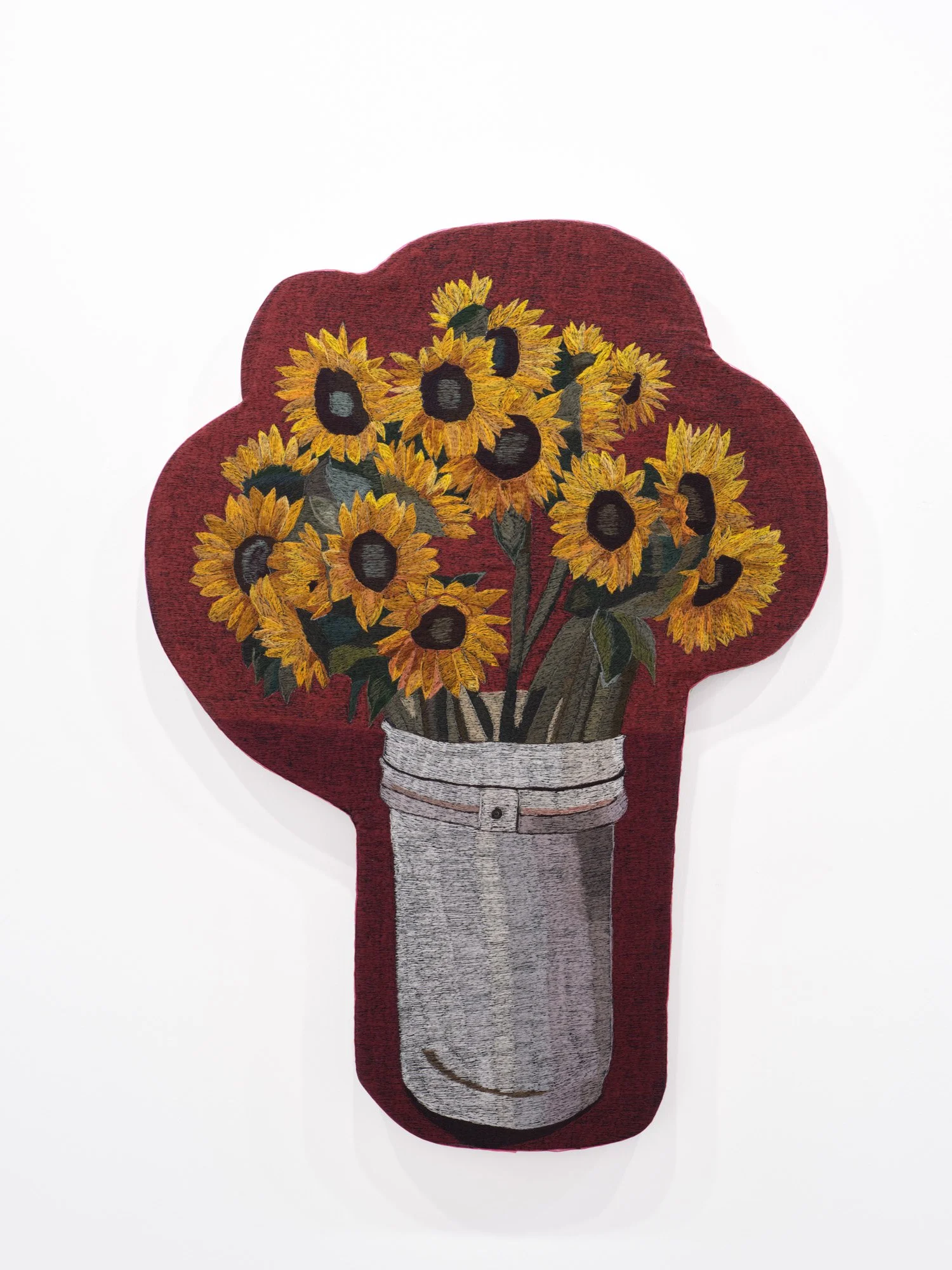 Erick Medel 
Sunflower Bucket (both prosperity and danger), 2026 
Polyester thread on denim, shaped panel, embroidered ribbon 
31 x42 inches
