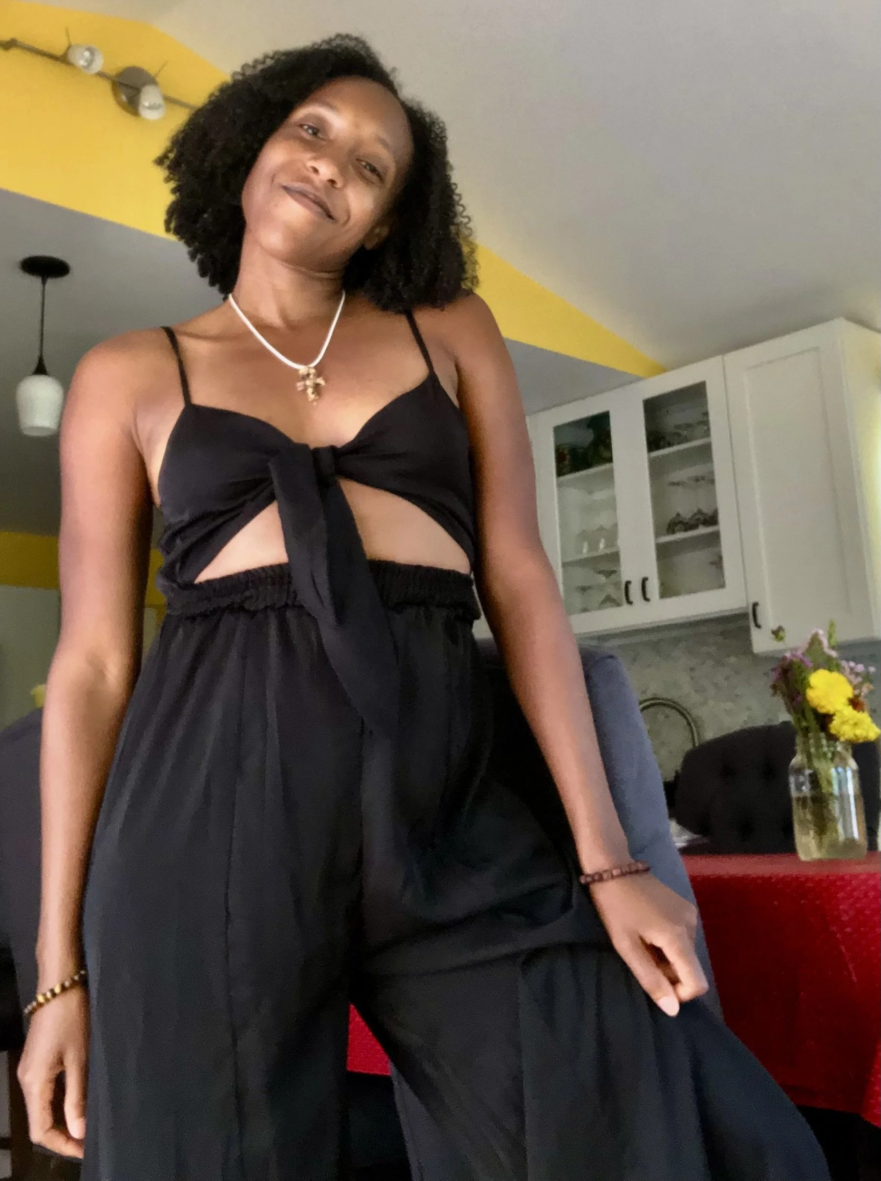 Picture Lawless Lawyer Black jumpsuit kitchen background yellow walls