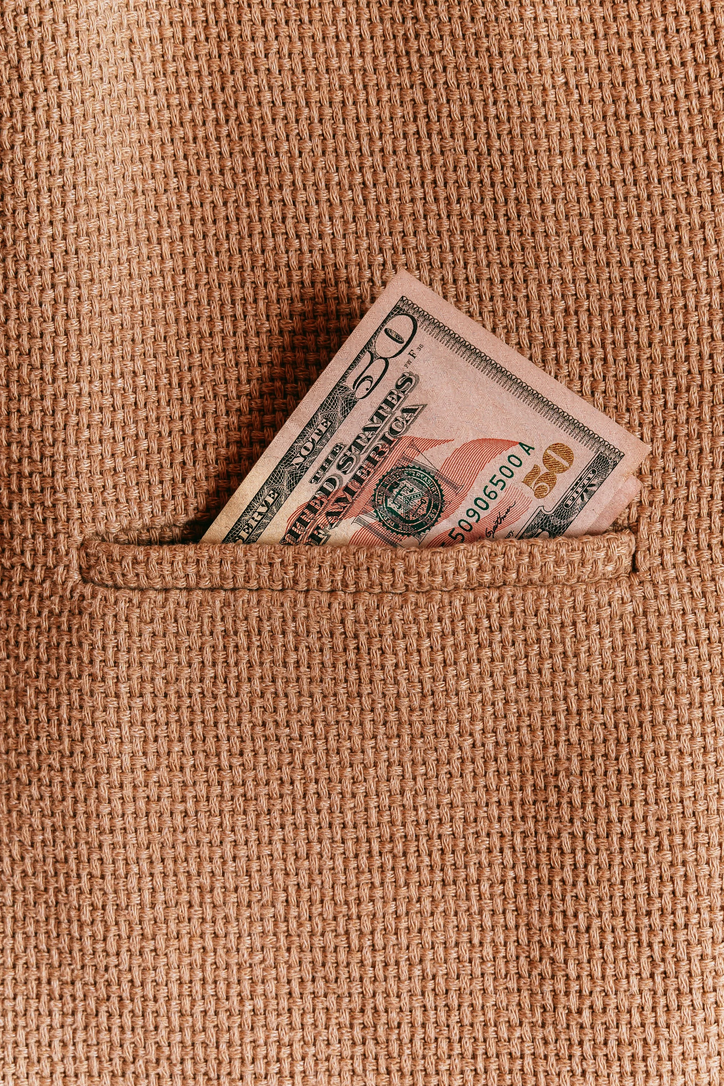 brown tweed coat pocket fifty dollar bill poking out