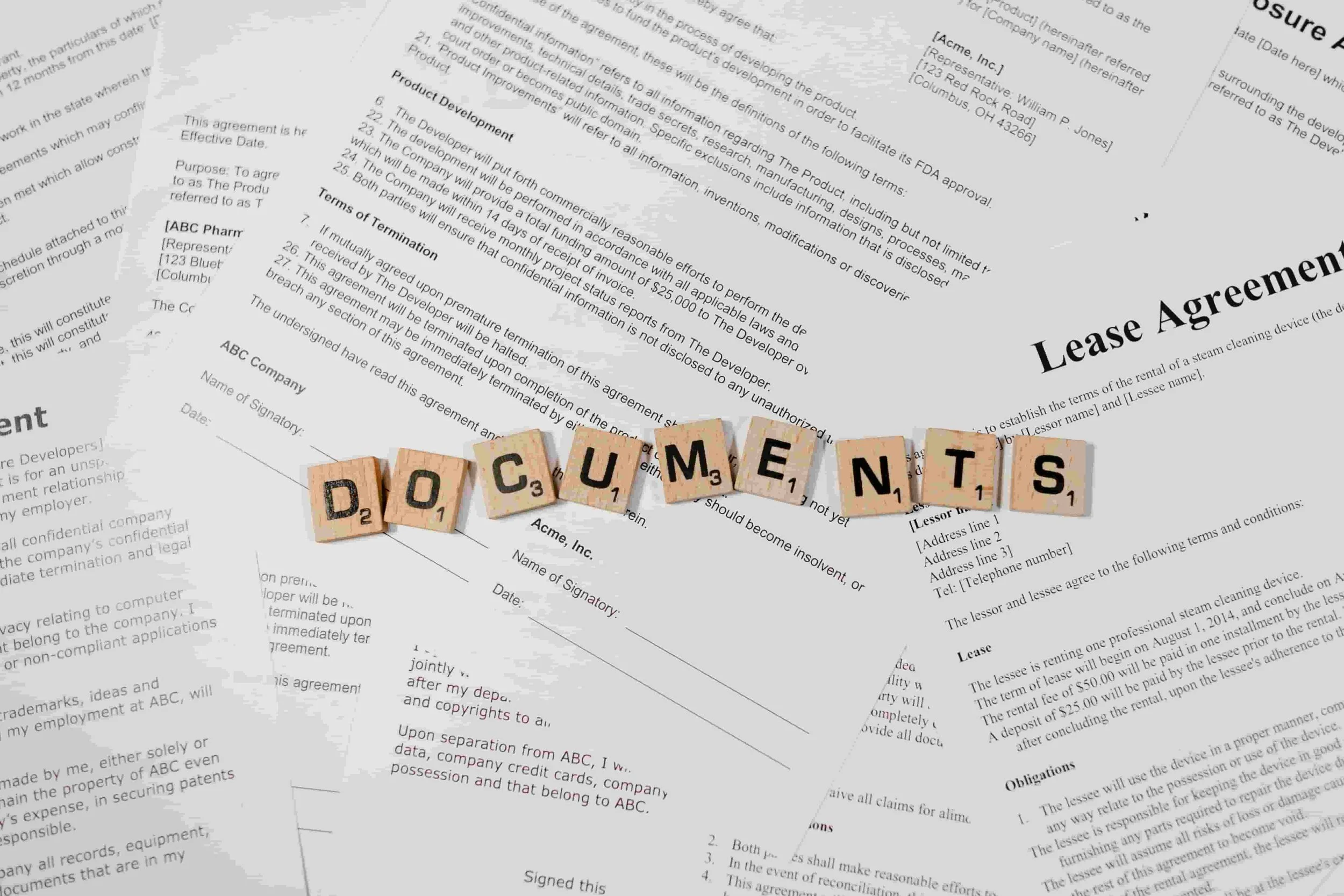 scattered documents wooden scrabble letters on top spelling docuents