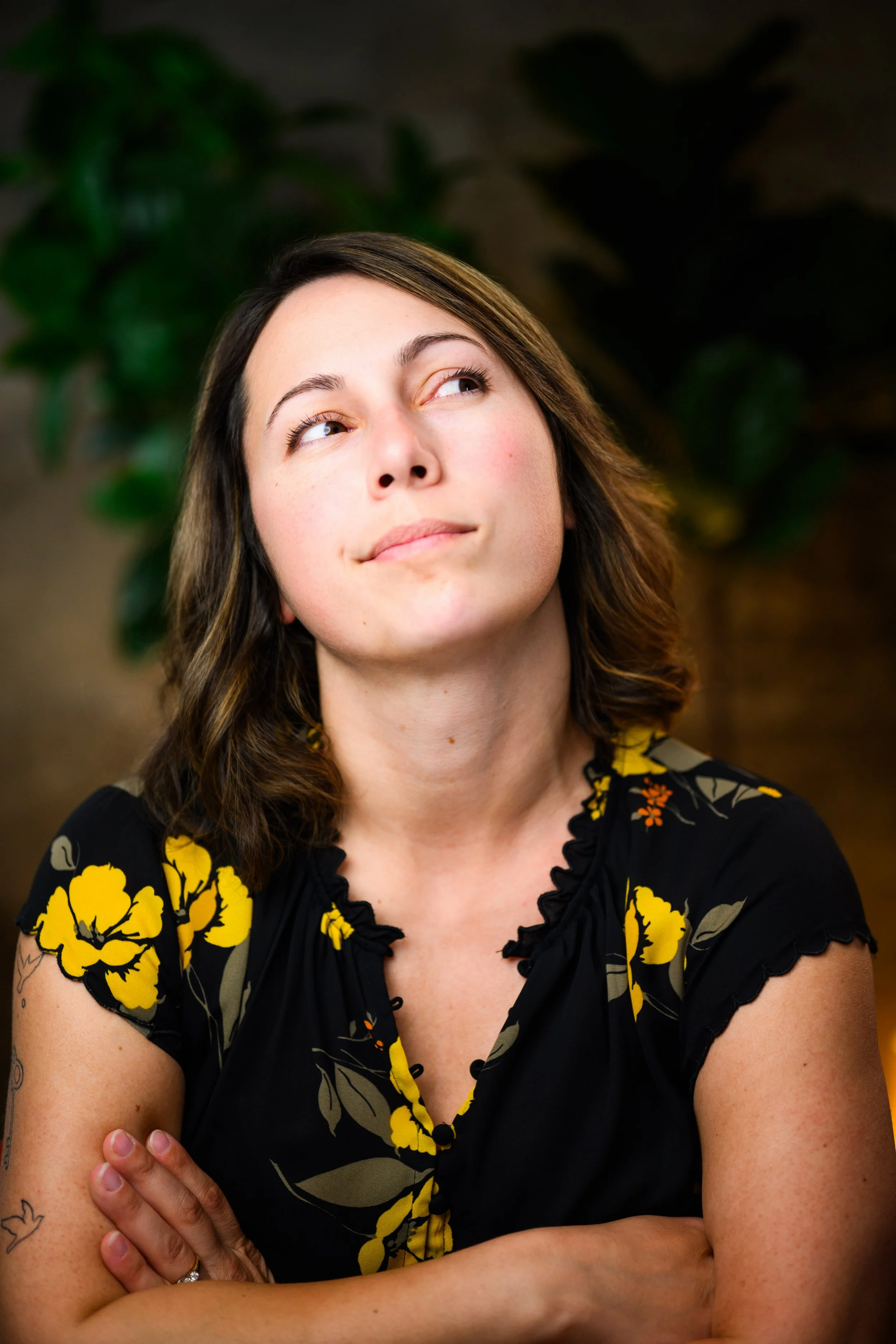 Woman in a yellow and black blouse looking away