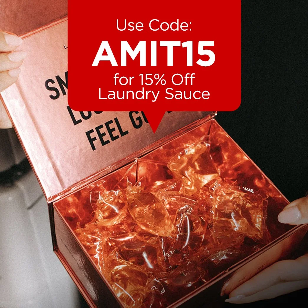 Open red box of laundry sauce detergent pods, with a sign inside that reads 'Smell good, look good, feel good.'