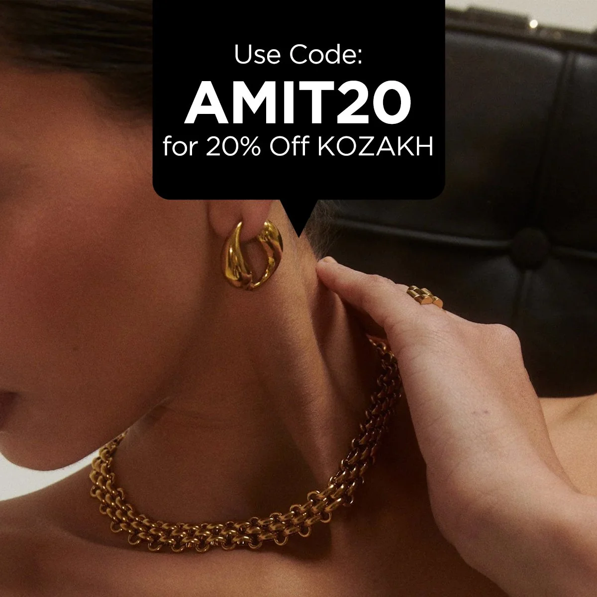 Close-up of a person wearing gold jewelry, including a chain necklace, hoop earrings, and rings, with a promotional code overlay offering 20% off.