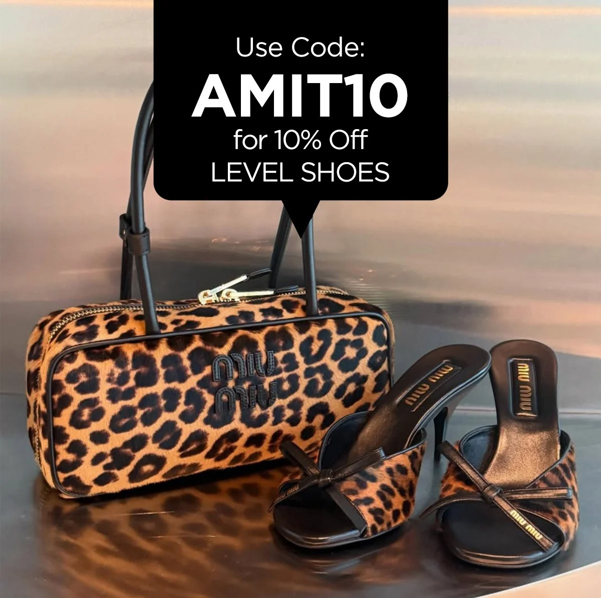 A leopard print handbag and matching high-heeled sandals on a reflective surface with a black sign overhead offering a 10% discount using code AMIT10 for level shoes.