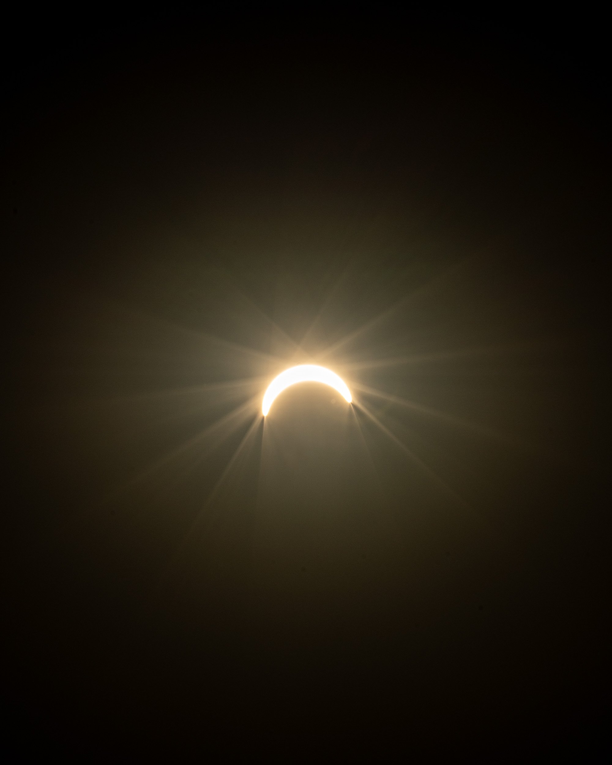 A solar eclipse showing the moon partially blocking the sun, creating a ring of sunlight around the moon.