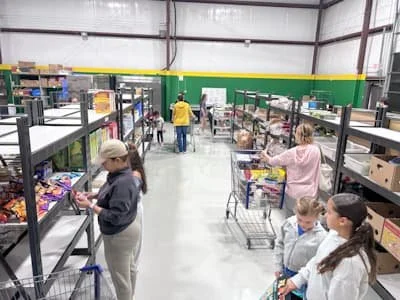 Food pantry aisle with shoppers and volunteers