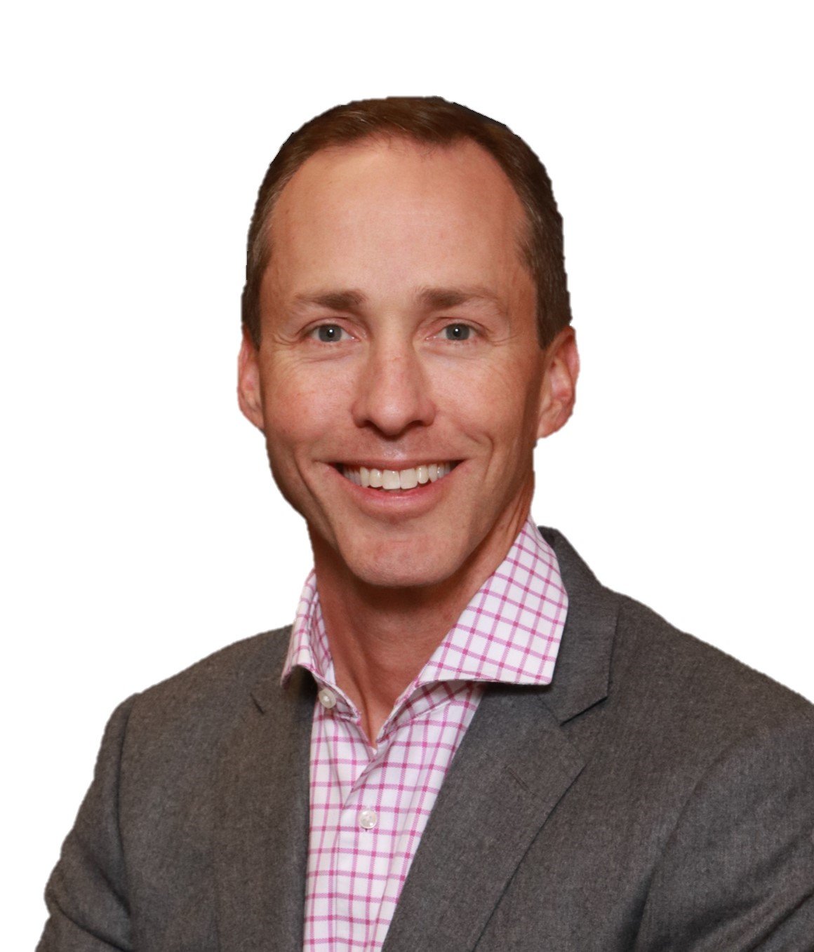 A man in a gray suit and pink checkered shirt smiling.