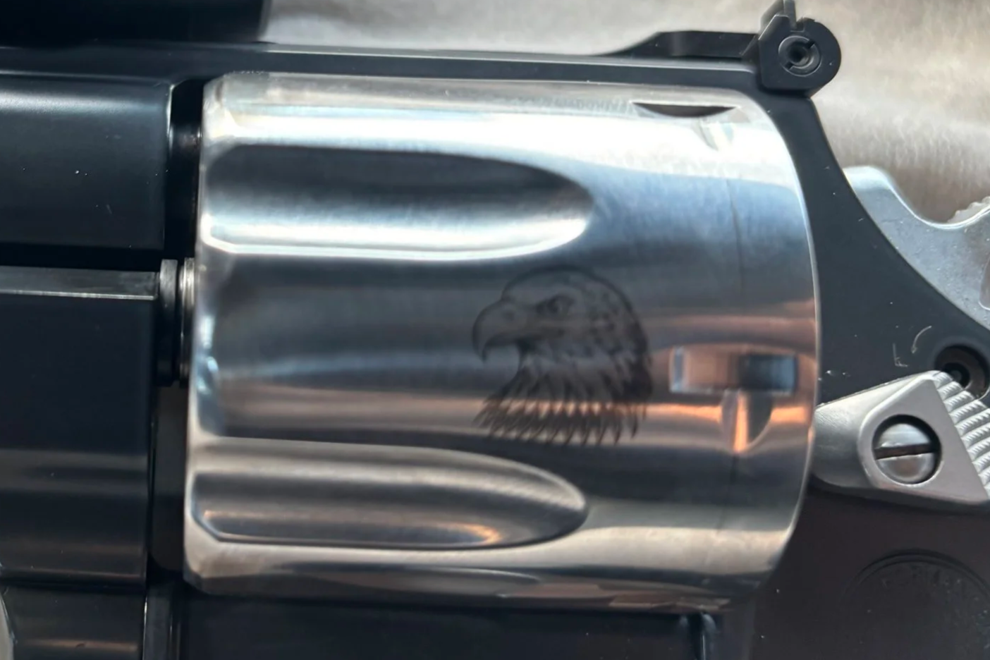 Close-up of a metallic component with an eagle head engraving