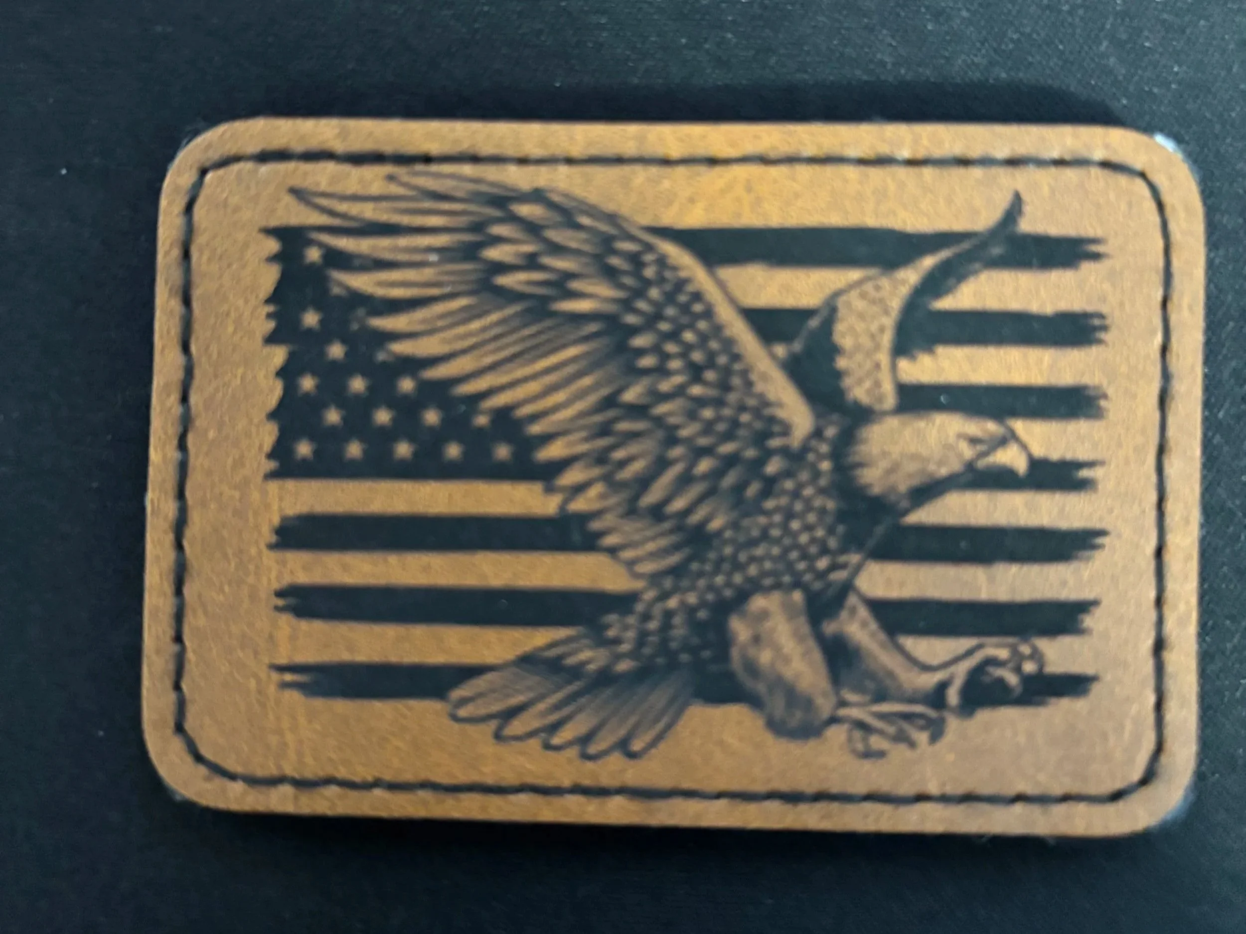 A sticker with an American flag background and a detailed illustration of an eagle with outstretched wings.