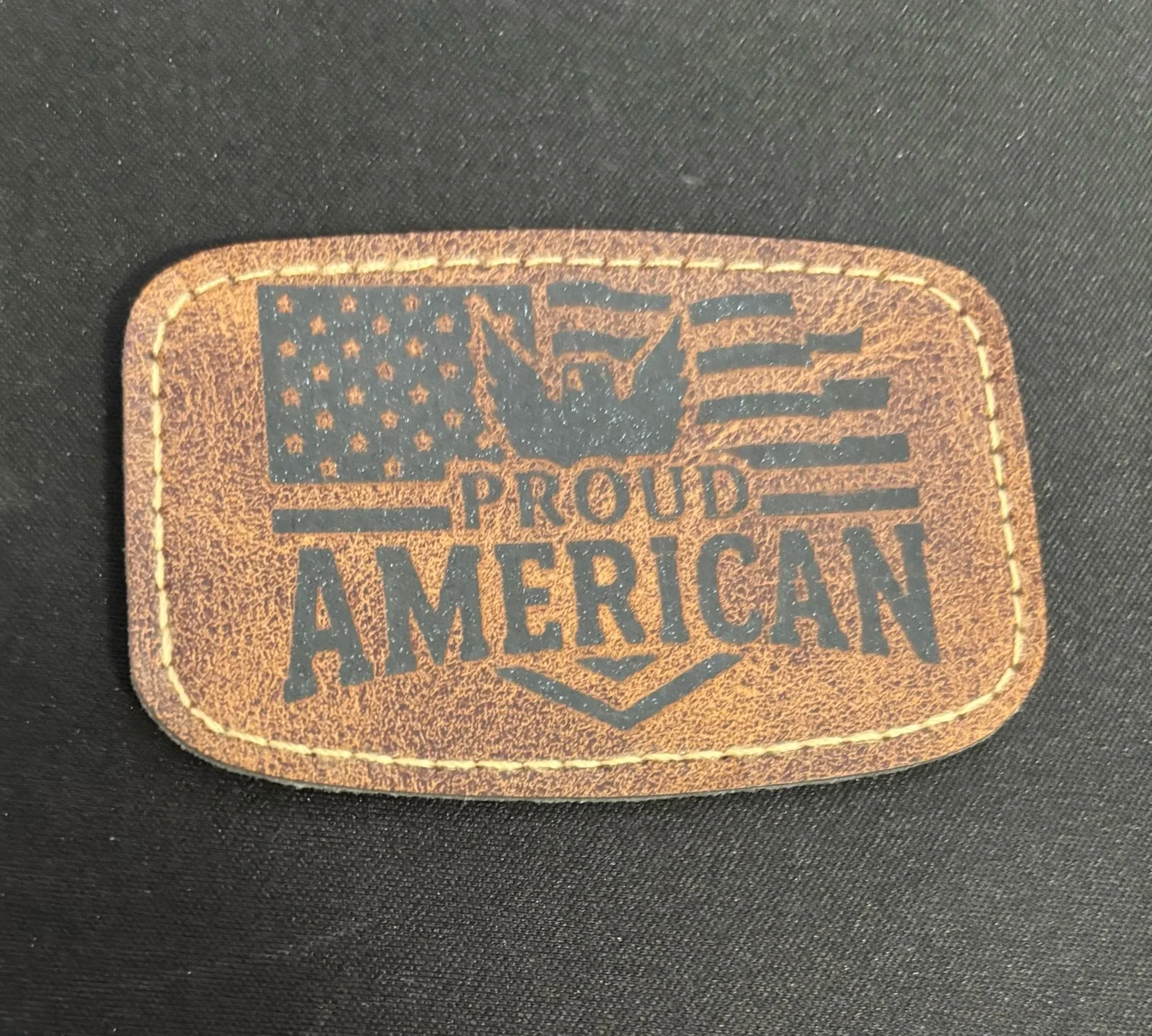Leather patch with American flag, eagle, and the words 'Proud American' written on it
