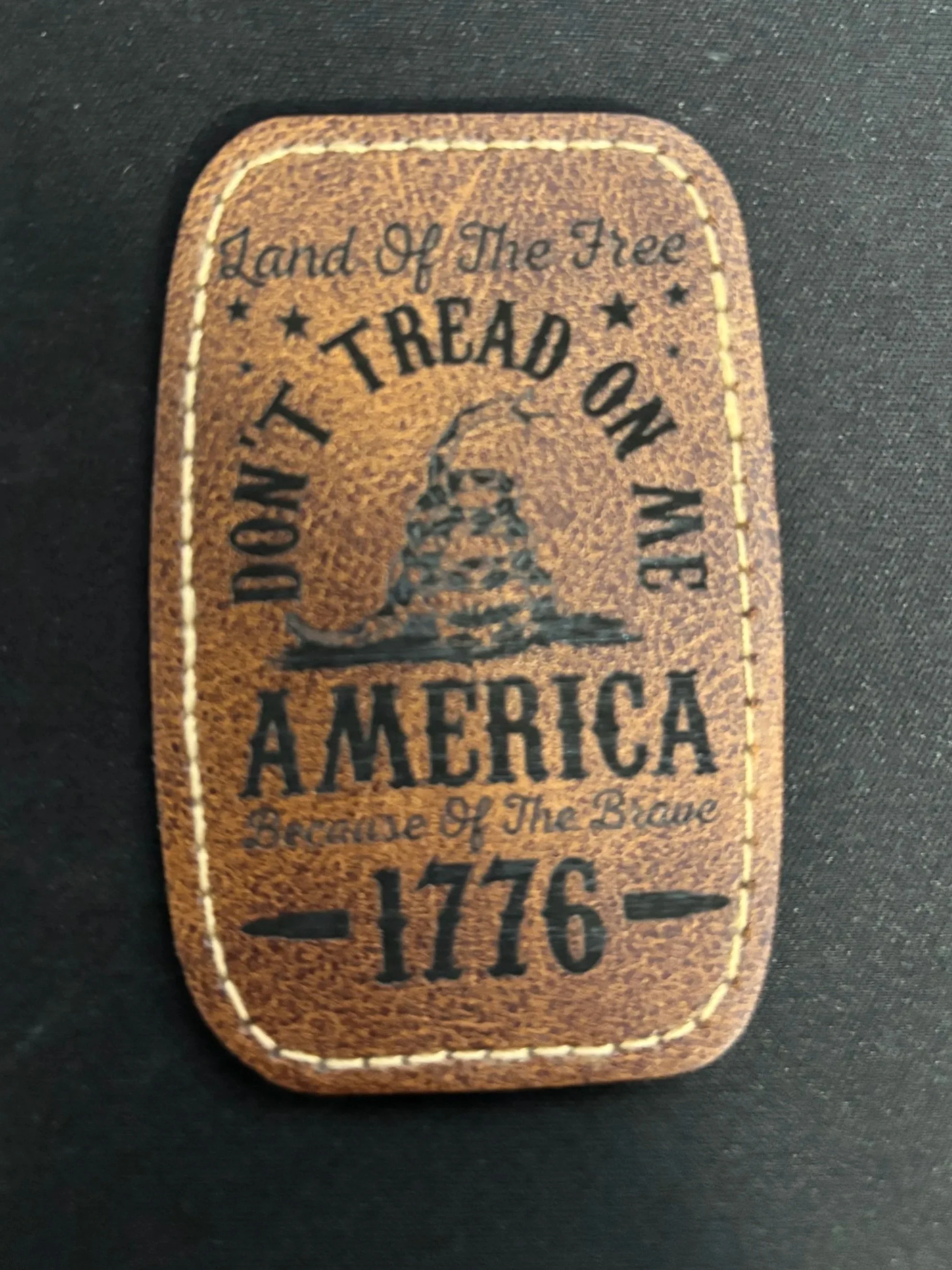 Leather patch with the text 'Land of the Free, Don't Tread on Me, America, Brave of the Brave, 1776' and an illustration of the Liberty Bell.