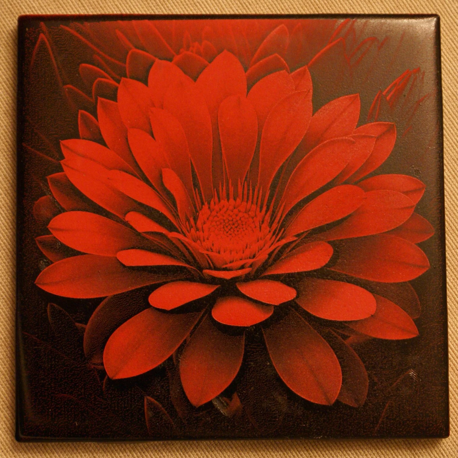 A square canvas print of a red flower with layered petals on a brown background.
