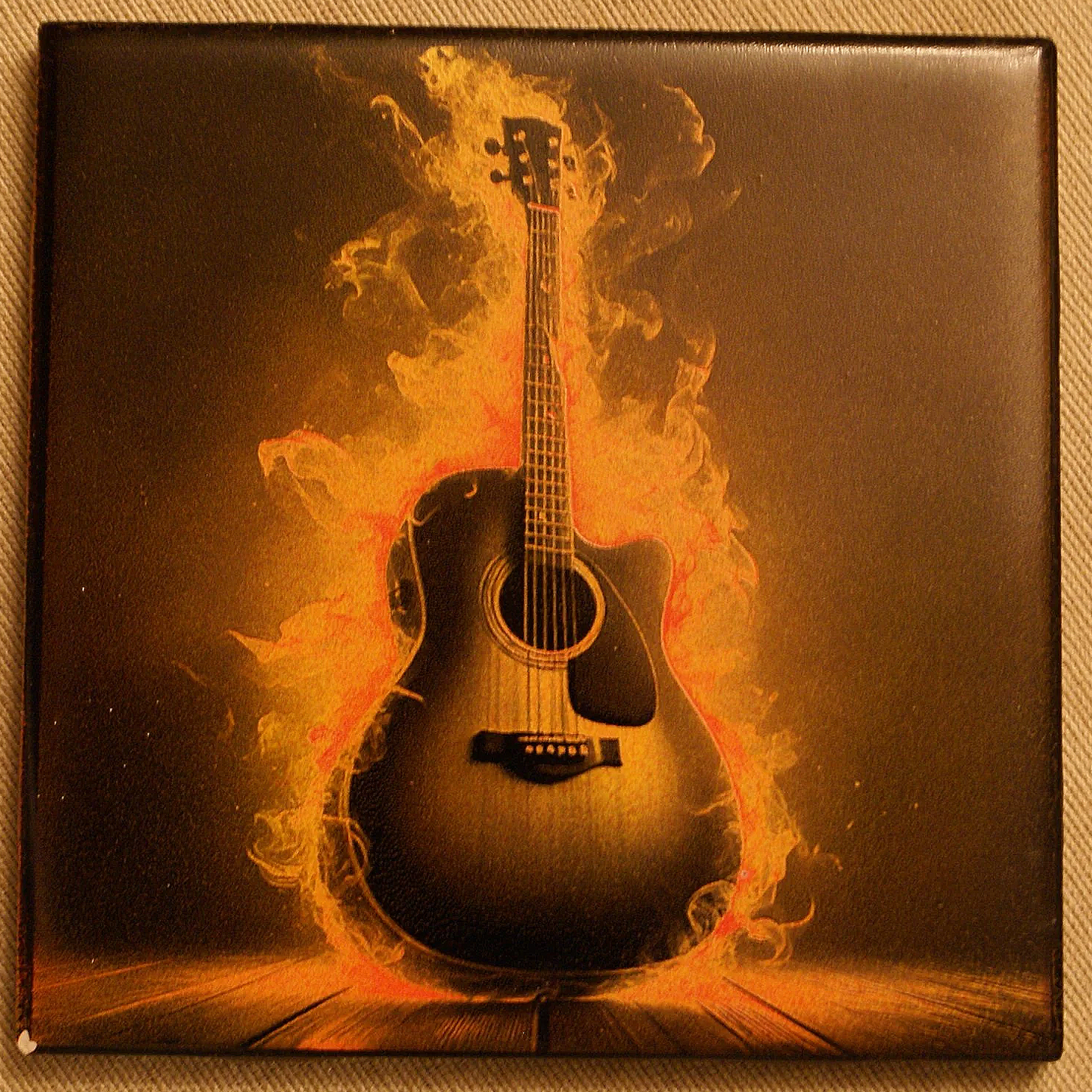 A guitar engulfed in orange and yellow flames, standing on a wooden floor, with a dark background.