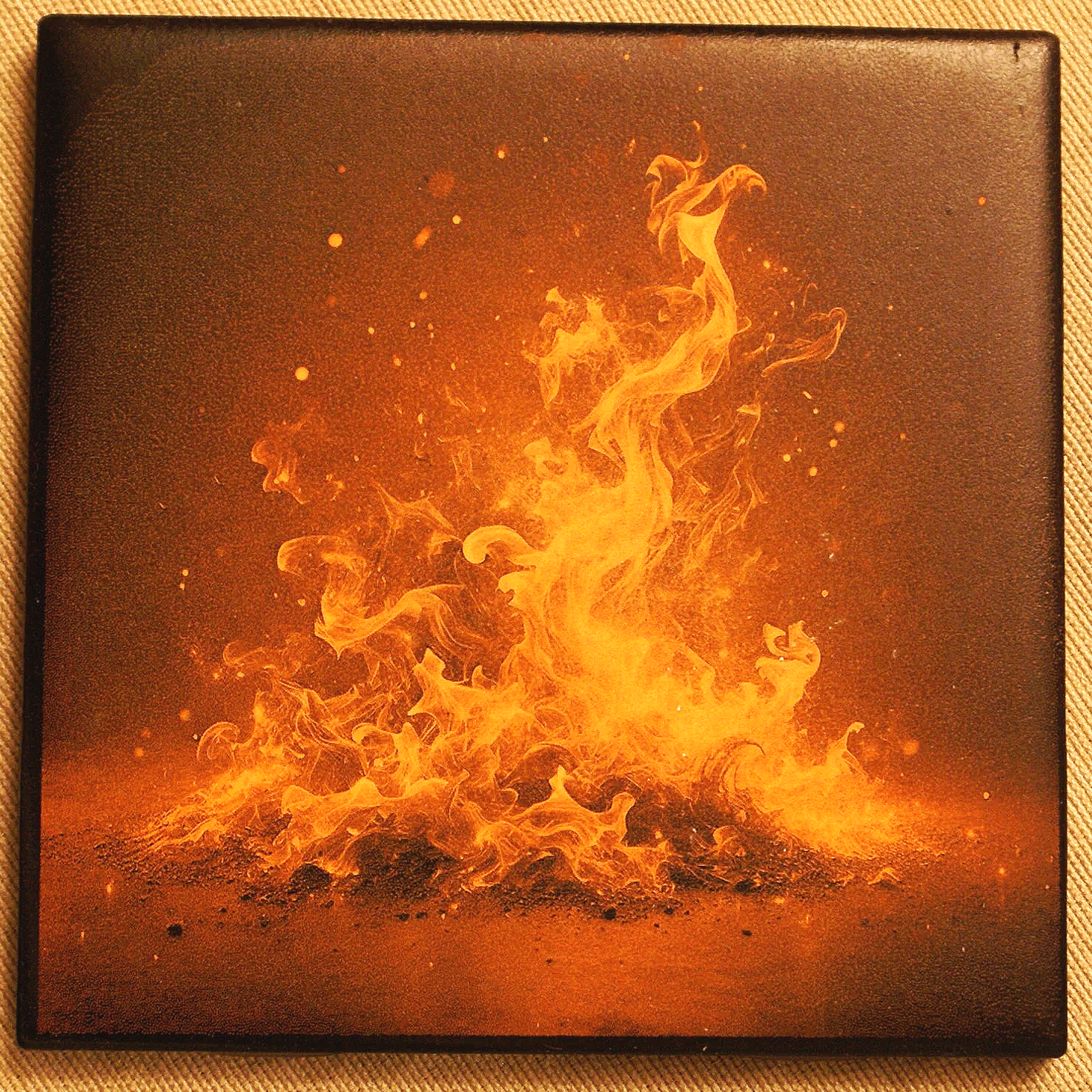 Image of bright orange and yellow flames rising with sparks on a dark background.
