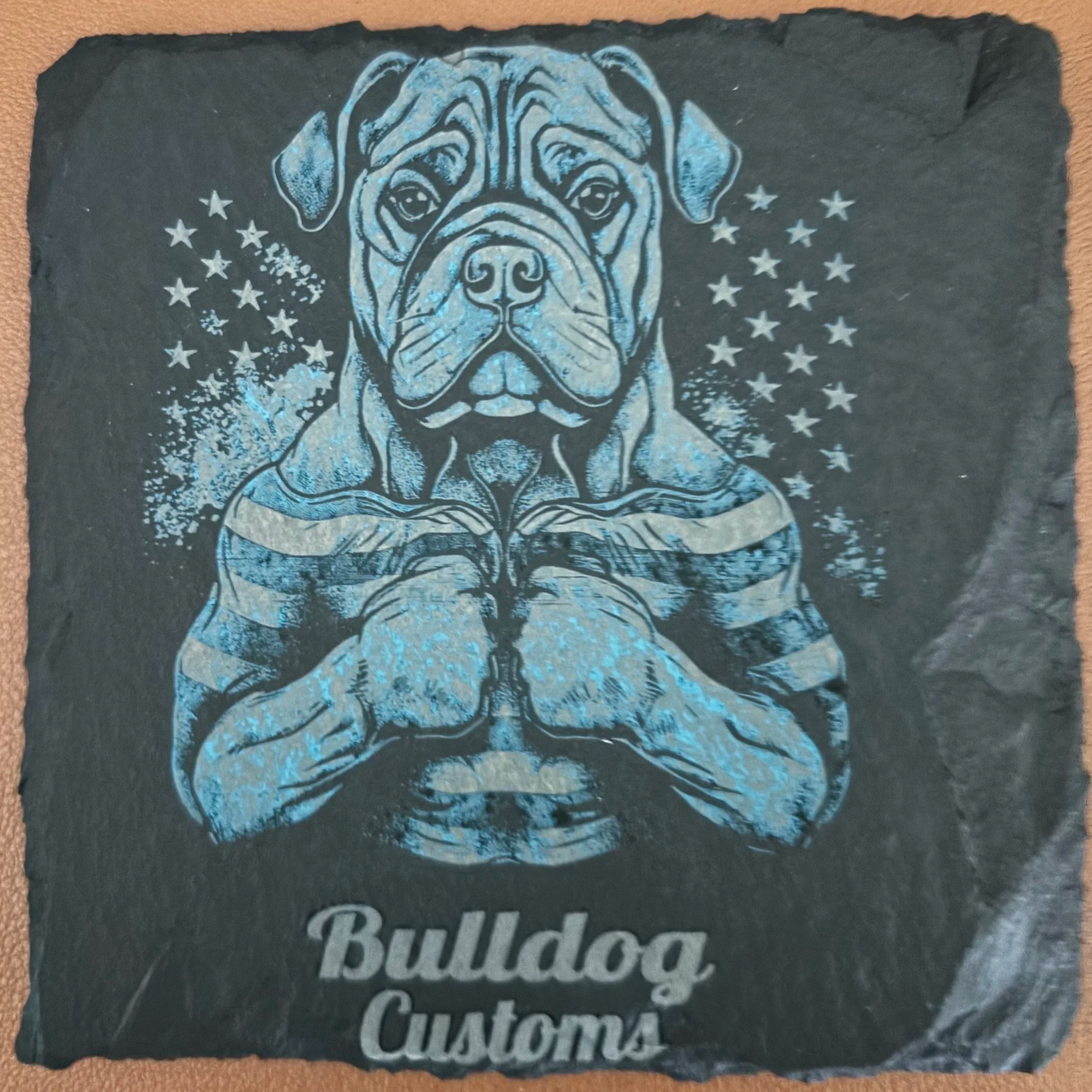 A graphic illustration of a muscular bulldog with a serious expression, framed by a background of stars, with the words "Bulldog Customs" at the bottom.