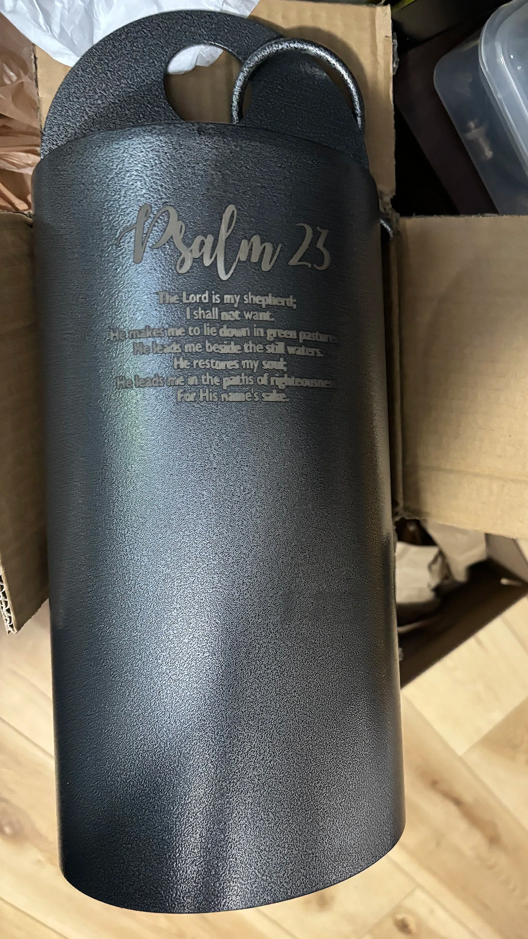 Black metal water bottle with engraved Psalm 23 text.